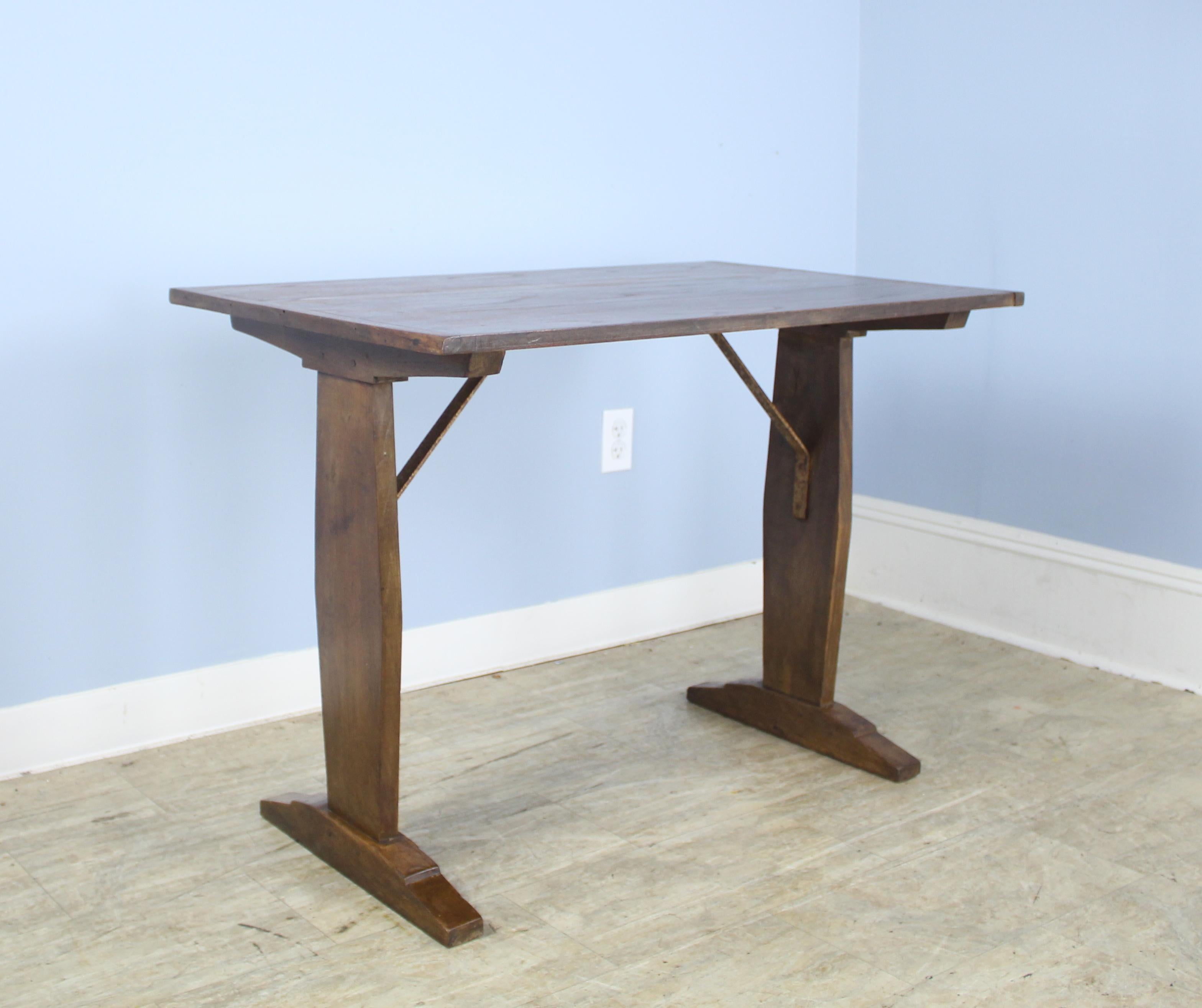 A pretty little breakfast or occasional table, originally from a French eatery. Good looking fruitwood color and grain, with interesting distressed iron supports. If you are looking for two, we have an almost identical one, reference #0621-M68A.