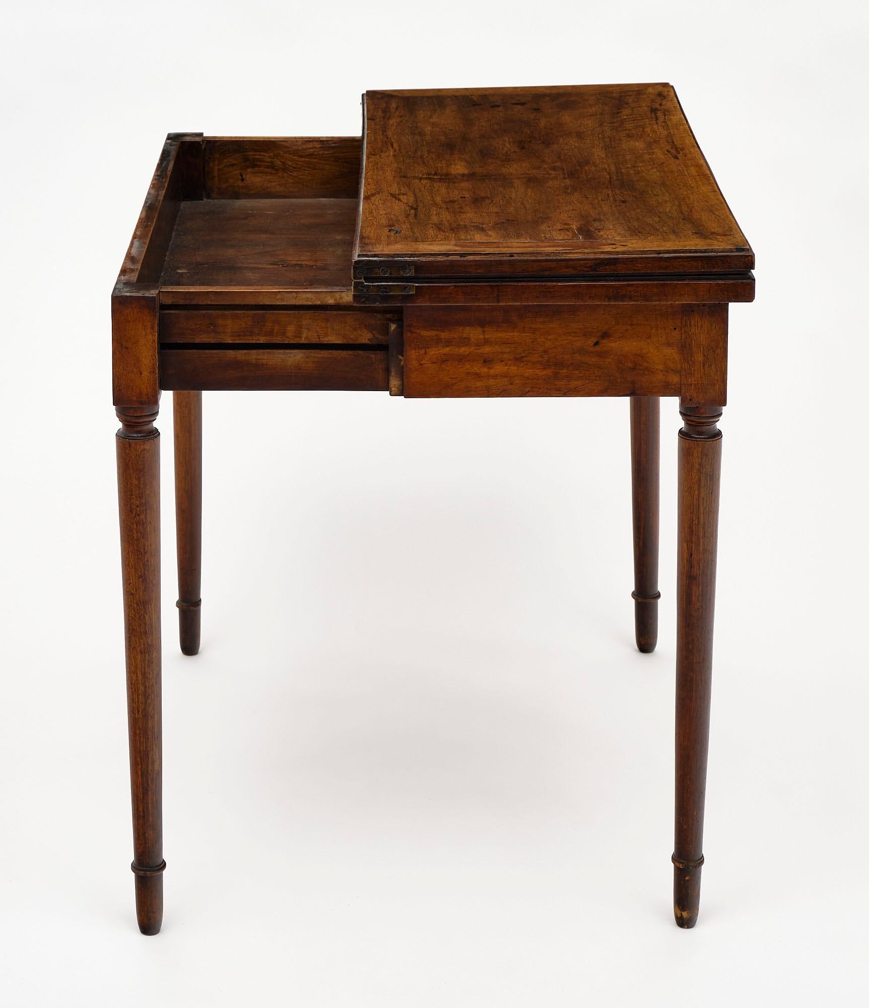 French antique game table made of finely crafted solid walnut with an adjustable apron that enables the top to open out to a felted playing surface. We love this unique and quality piece!