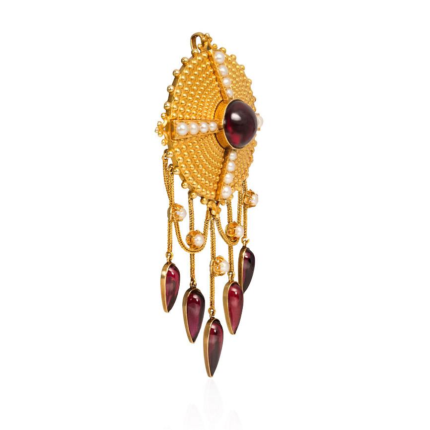 An antique gold and pearl circular pendant brooch with a central cabochon garnet suspending chain swags and terminating in a fringe of pearls and drop-shaped garnets, in 18k.  France
(Neck chain not included.)