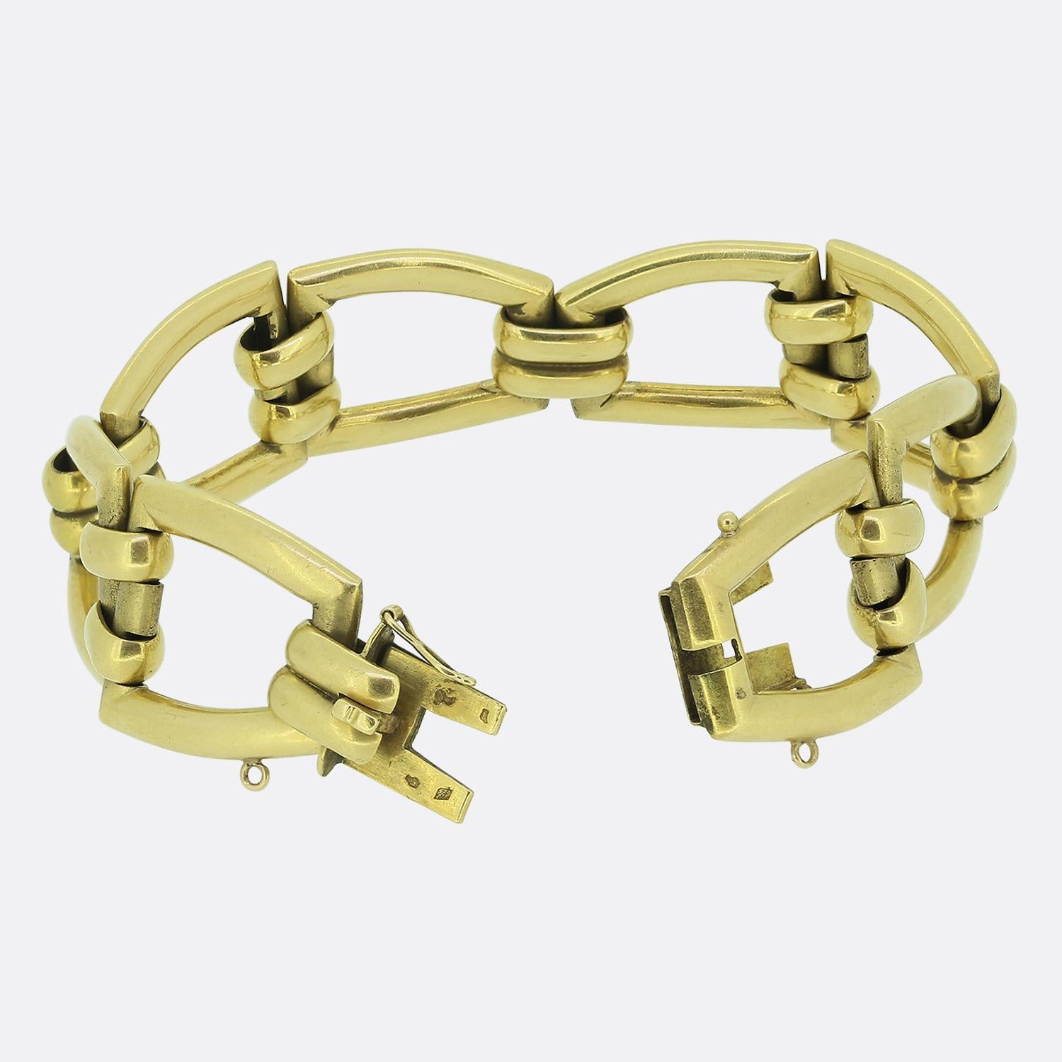 Here we have a fine quality gate bracelet. Crafted in France from a rich 18ct yellow gold, this antique piece is comprised of wide open gated links with a plain smooth finish and concealable hidden clasp. This versatile piece is perfect for everyday