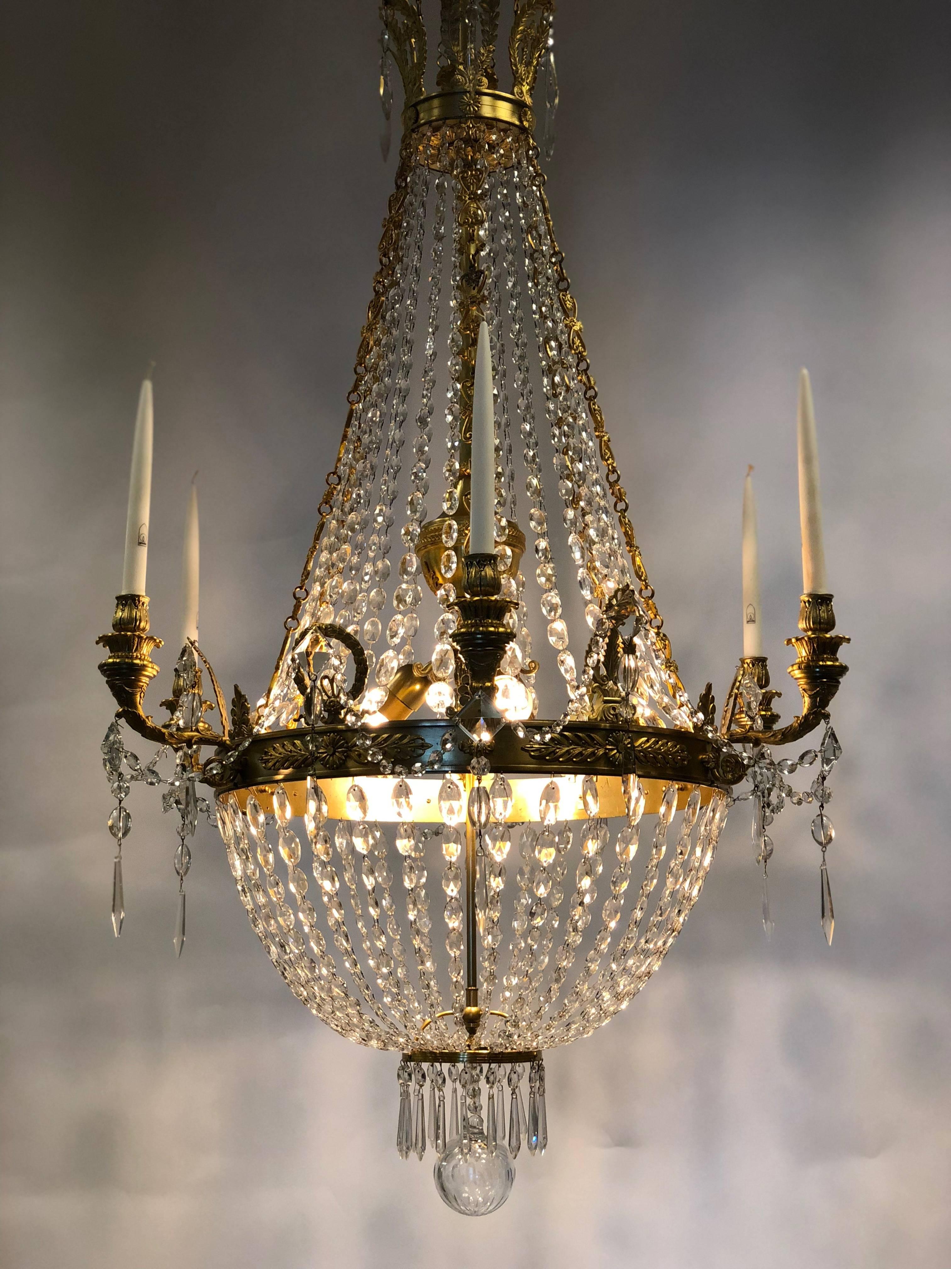This antique French chandelier is recently restored.
Six arms are mounted on the bronze ring, the used crystals are oval.
 