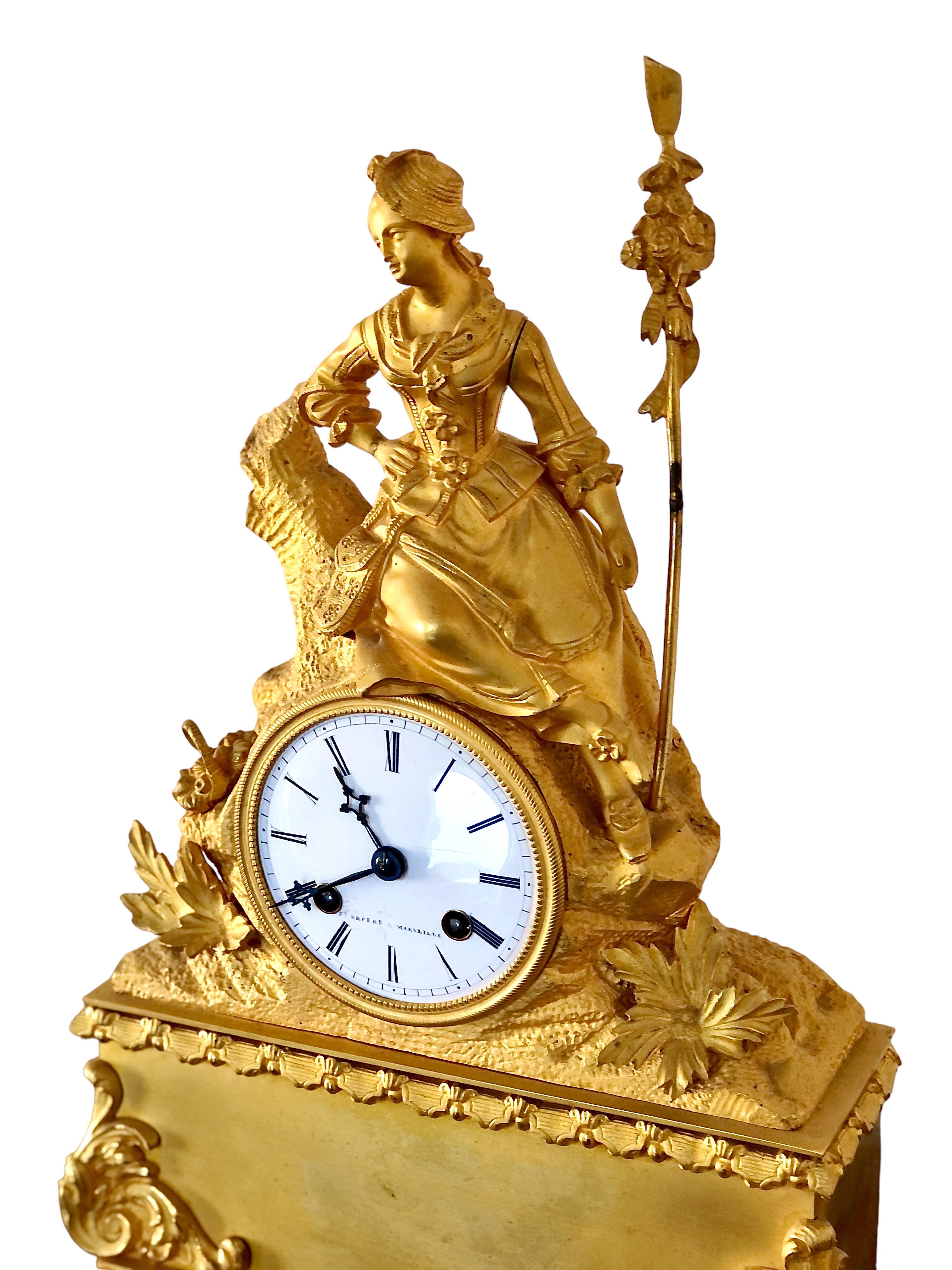 A superb quality 19th century French bronze gilt mantel clock, retaining its original glass dome, and adorned with a finely detailed rustic female figure in period dress, reclining on a tree stump surrounded by woodland leaves at its base. Caught in