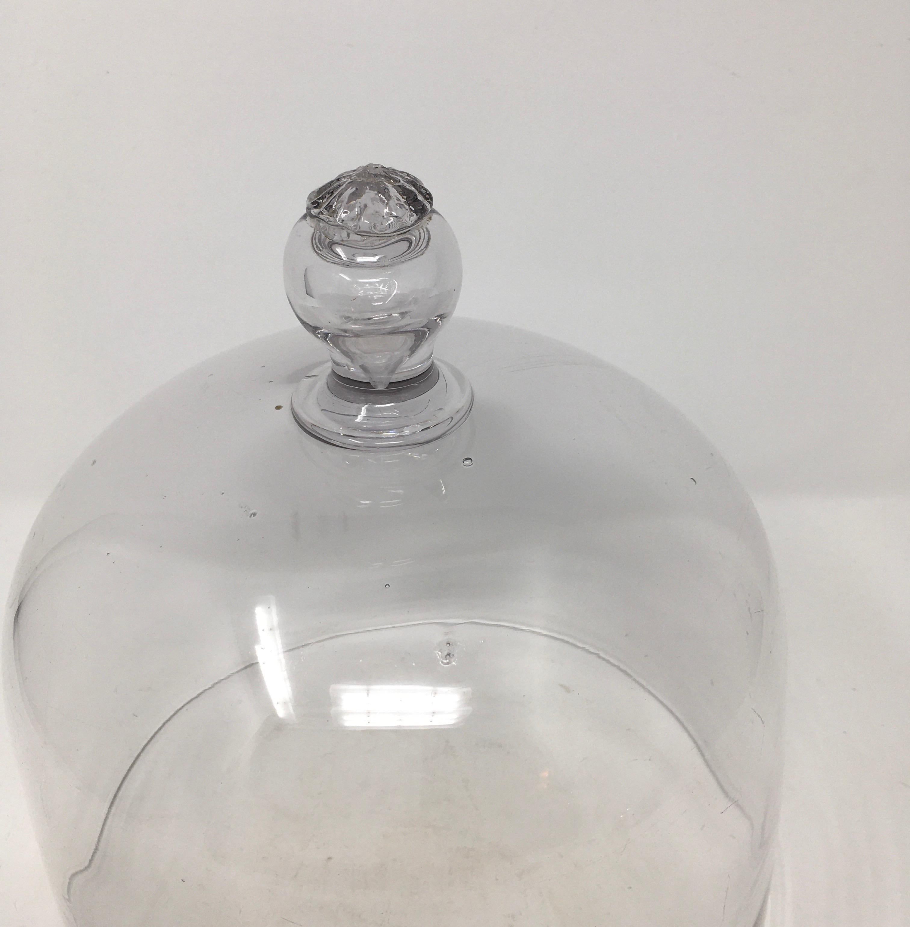 French antique Patisserie glass dome cloche with a solid cut glass knob handle. Smooth and polished glass, these were used in French Patisseries to cover and display pastries.
