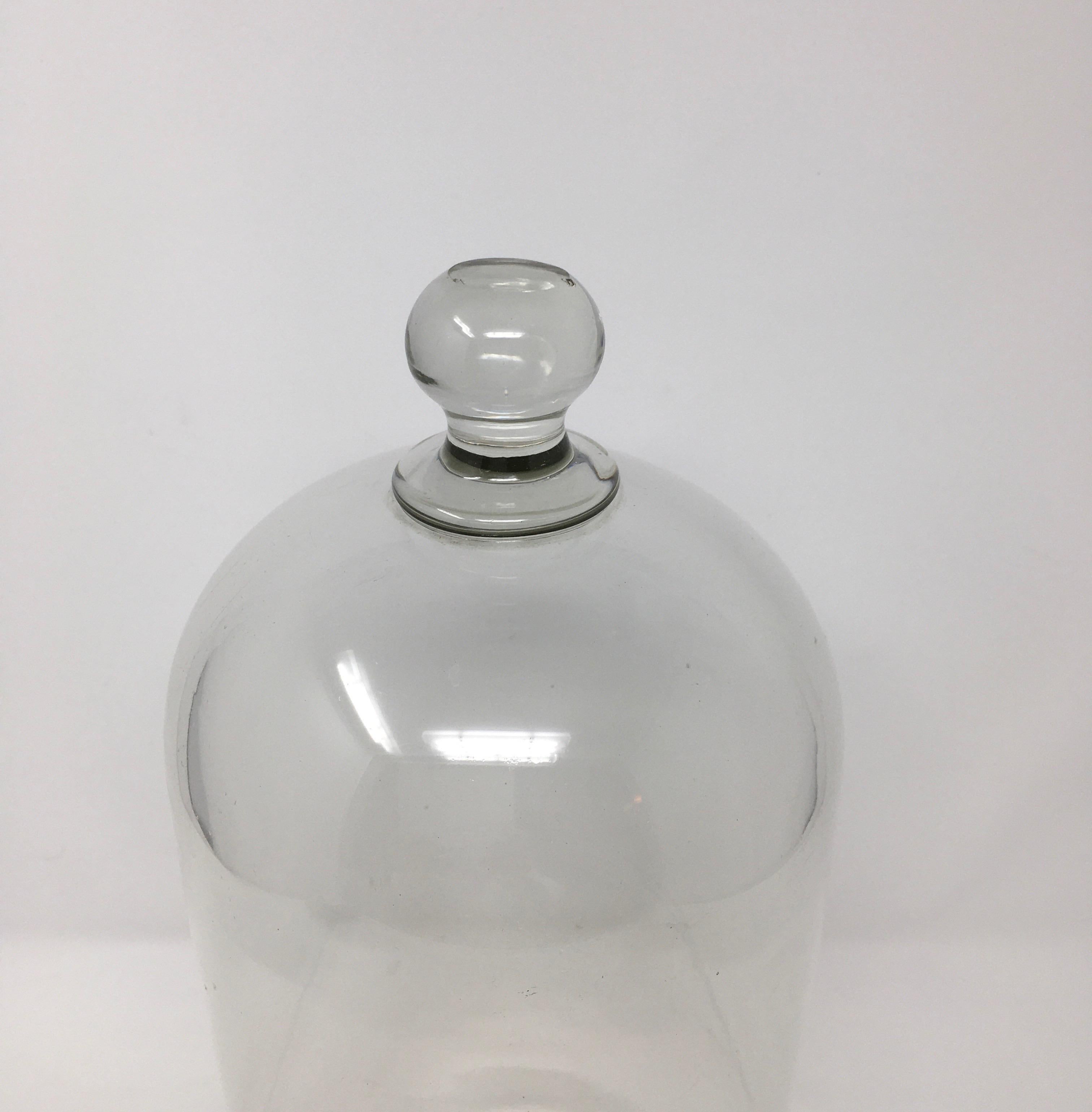 French antique patisserie glass dome cloche with a solid glass knob handle. Smooth and polished glass, these were used in French Shop's and Gardens to cover and display various items.