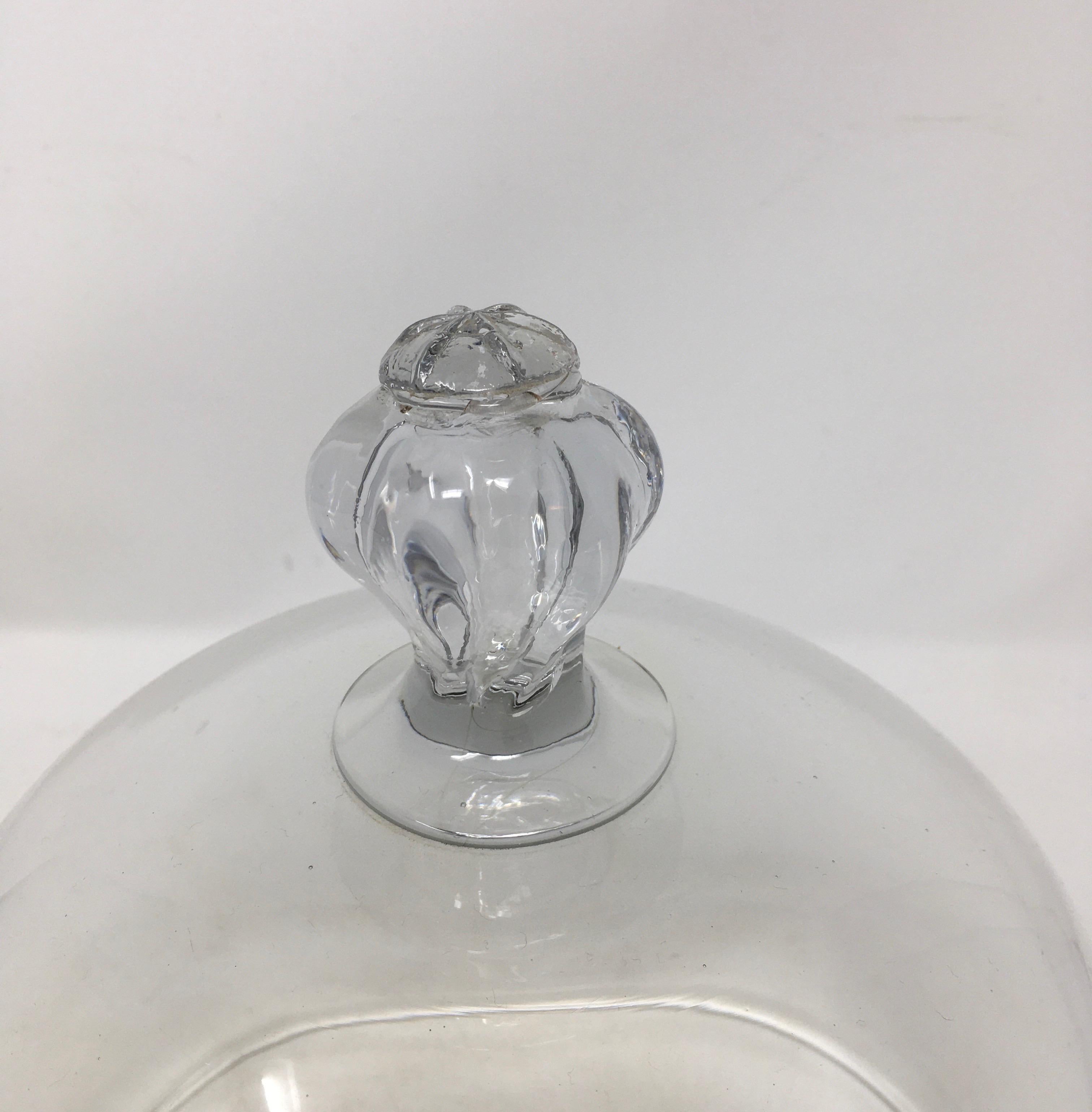 French antique glass dome cloche with a solid glass knob handle. Smooth and polished glass, these were used in French cheese shop's and patisseries to cover and display cheeses and baked goods.



This piece weighs 3 lbs.