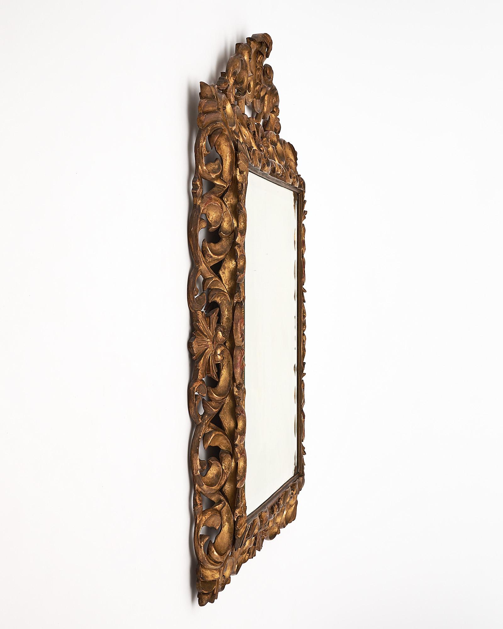 Mirror, French, from the Napoleon III period. This mirror is made of hand-carved wood with gold leafing throughout.