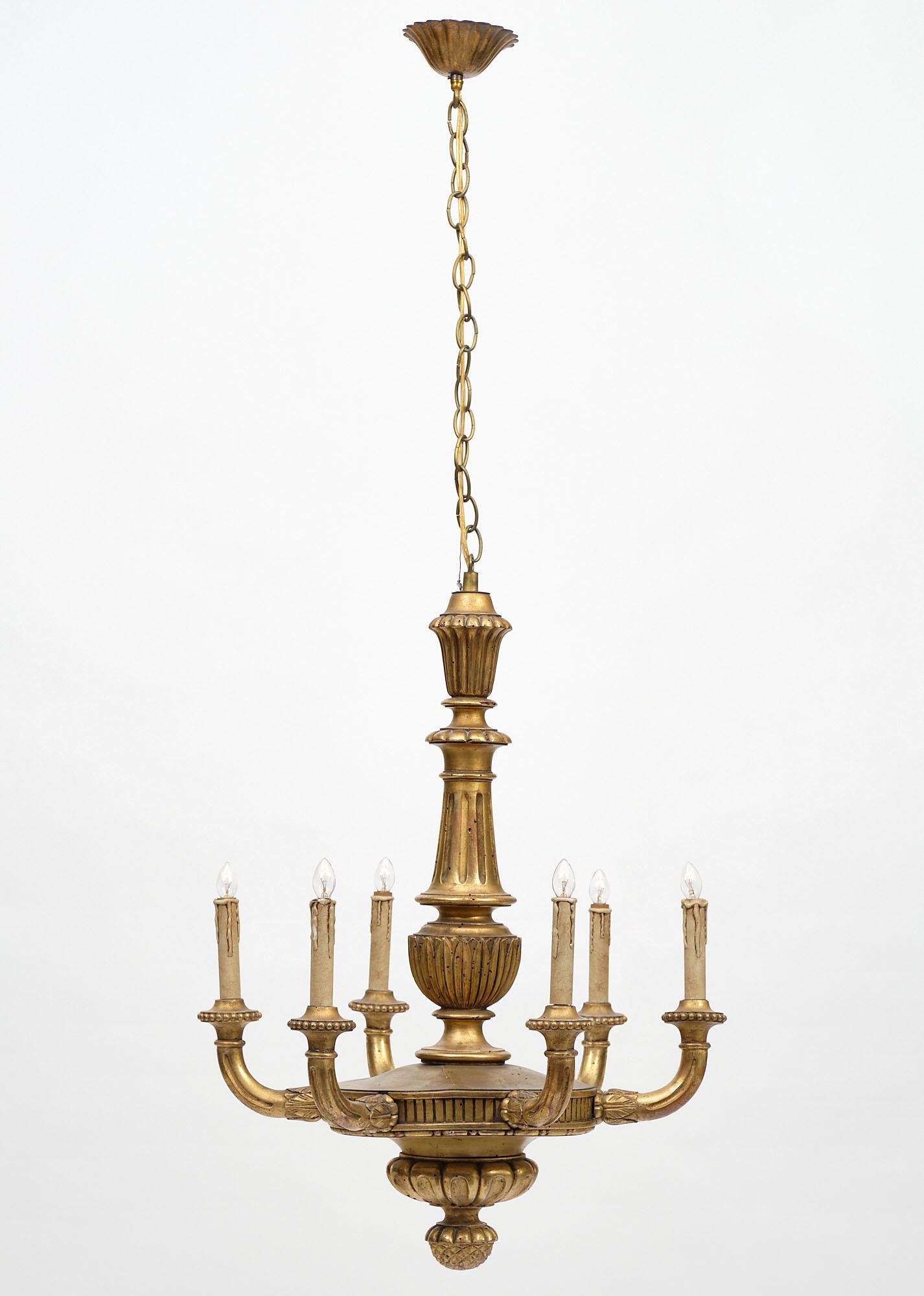 Gorgeous antique French Louis XIV style chandelier in hand carved and gold leafed wood, acanthus leaf details, pine cone finial, rewired.
