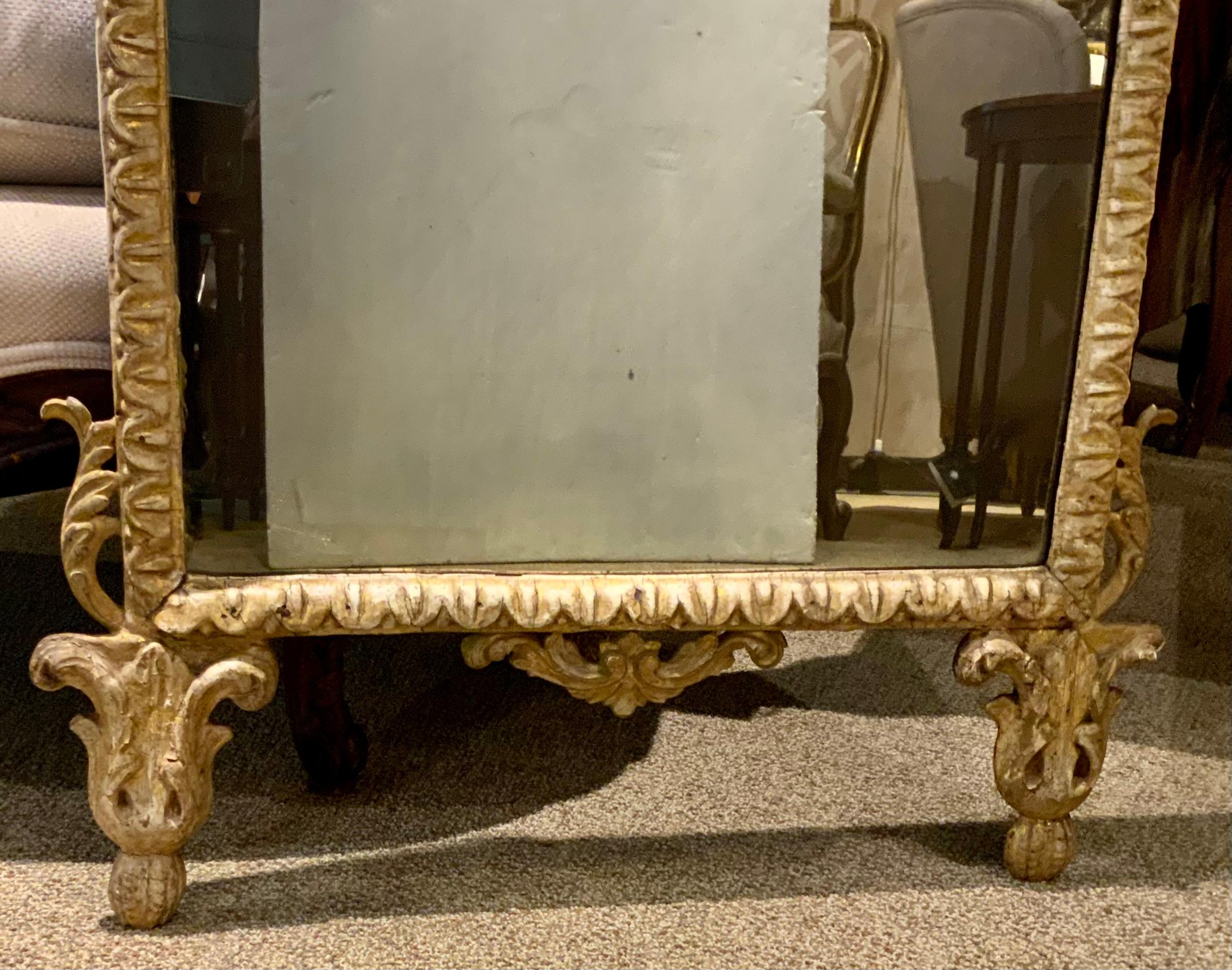 French hand carved and gilt mirror with the original antique mirror plate
Make this a very special piece.  The mirror plate is aged and cloudy
Which shows its beautiful age. The oval shaped mirror is centered at
The crest with a lovely bow motif