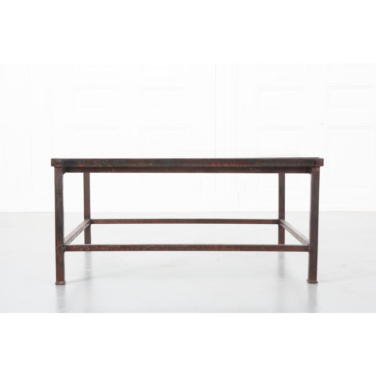 A wonderful marriage of old and new, this exceptional coffee or cocktail table has a newly fabricated base that incorporates a stunning architectural fragment, sourced from an antique French iron balcony surround, that is styled with scrolled