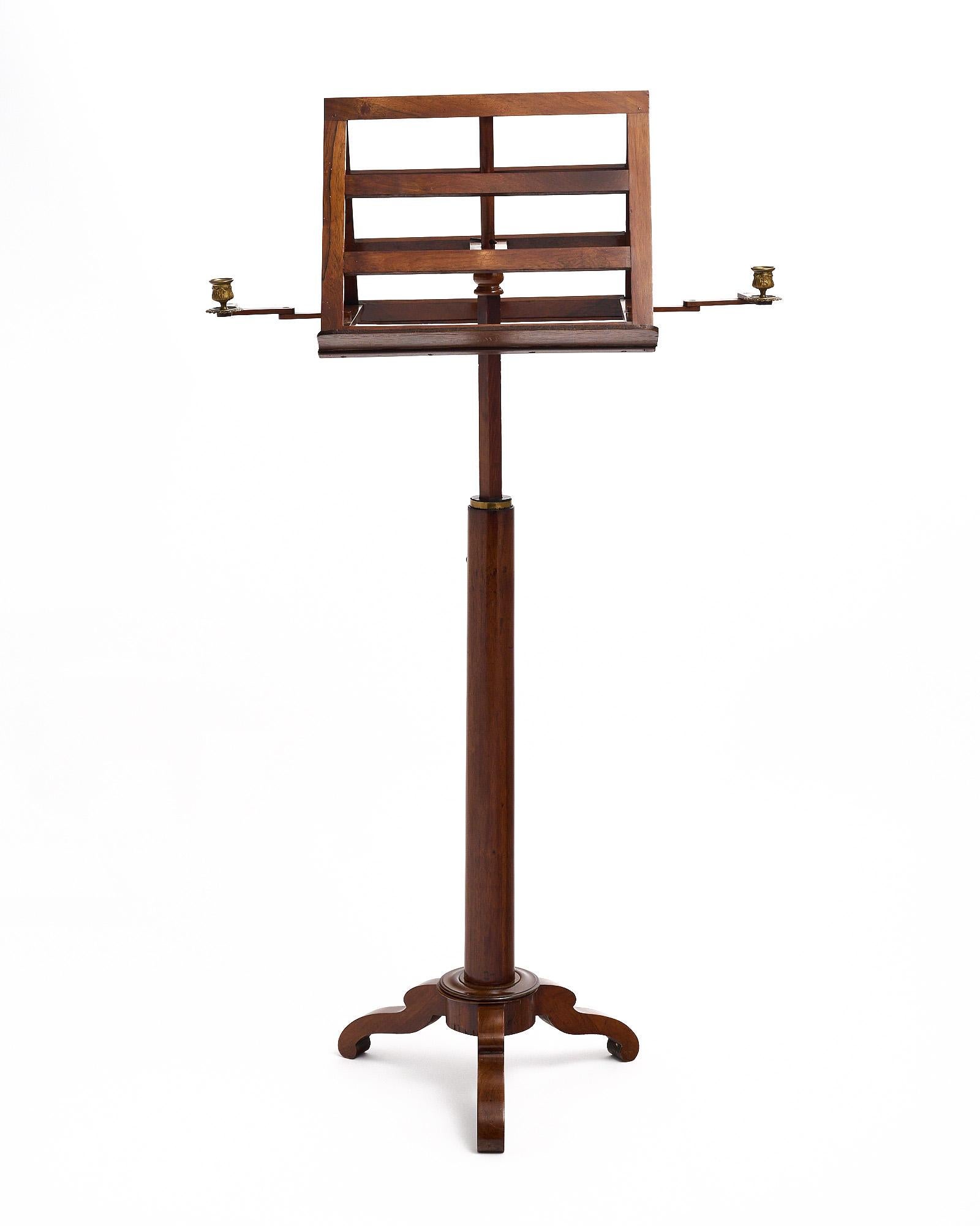 Lectern, French, featuring a beautiful hand-carved tripod foot and two brass candle holders on pivoting arms.

