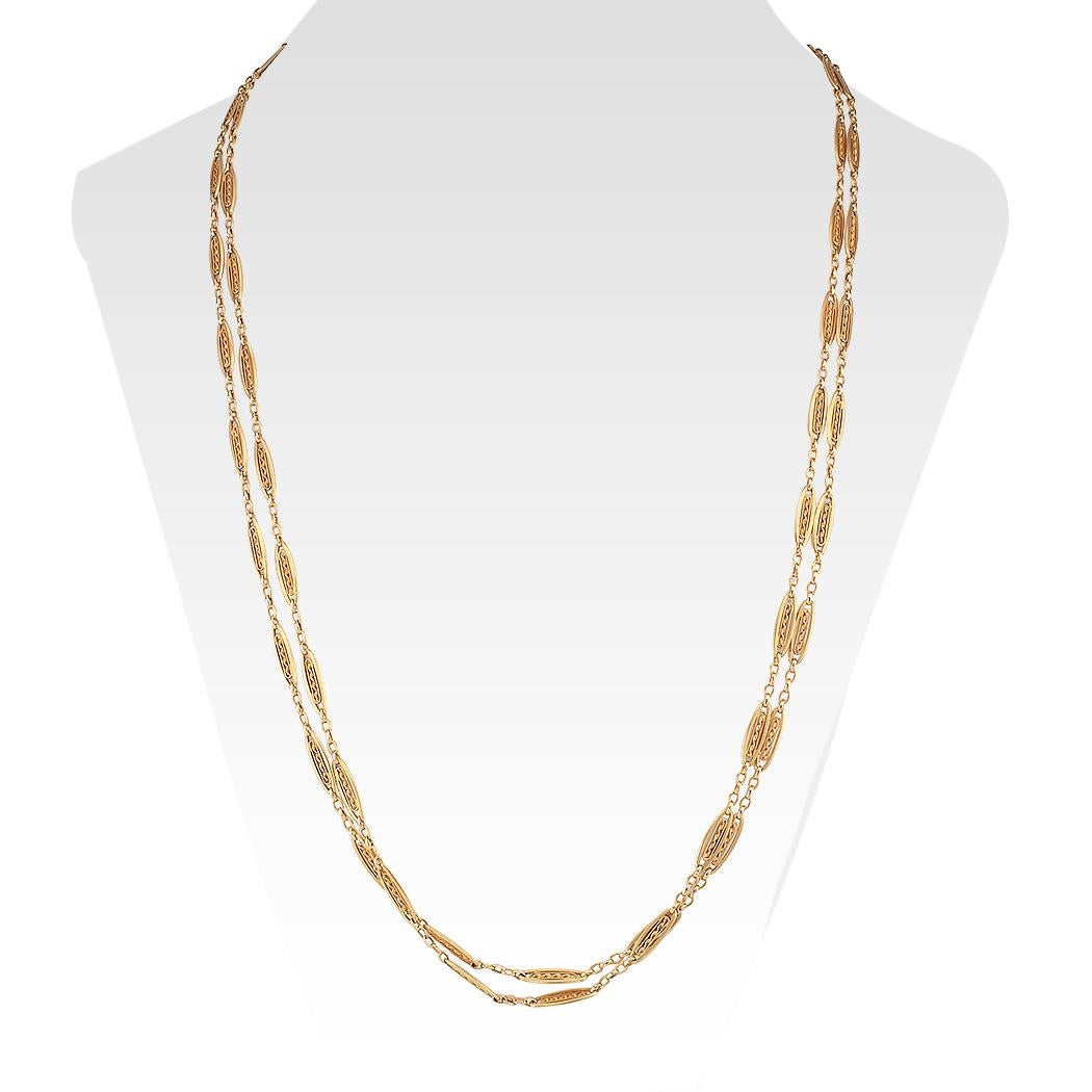 Antique French long gold chain necklace circa 1900. The 18-karat gold design comprises a series of handcrafted open work links completed by a slightly oversized clasp. We love the design of the links, their dimensionality, each encencapsulating a
