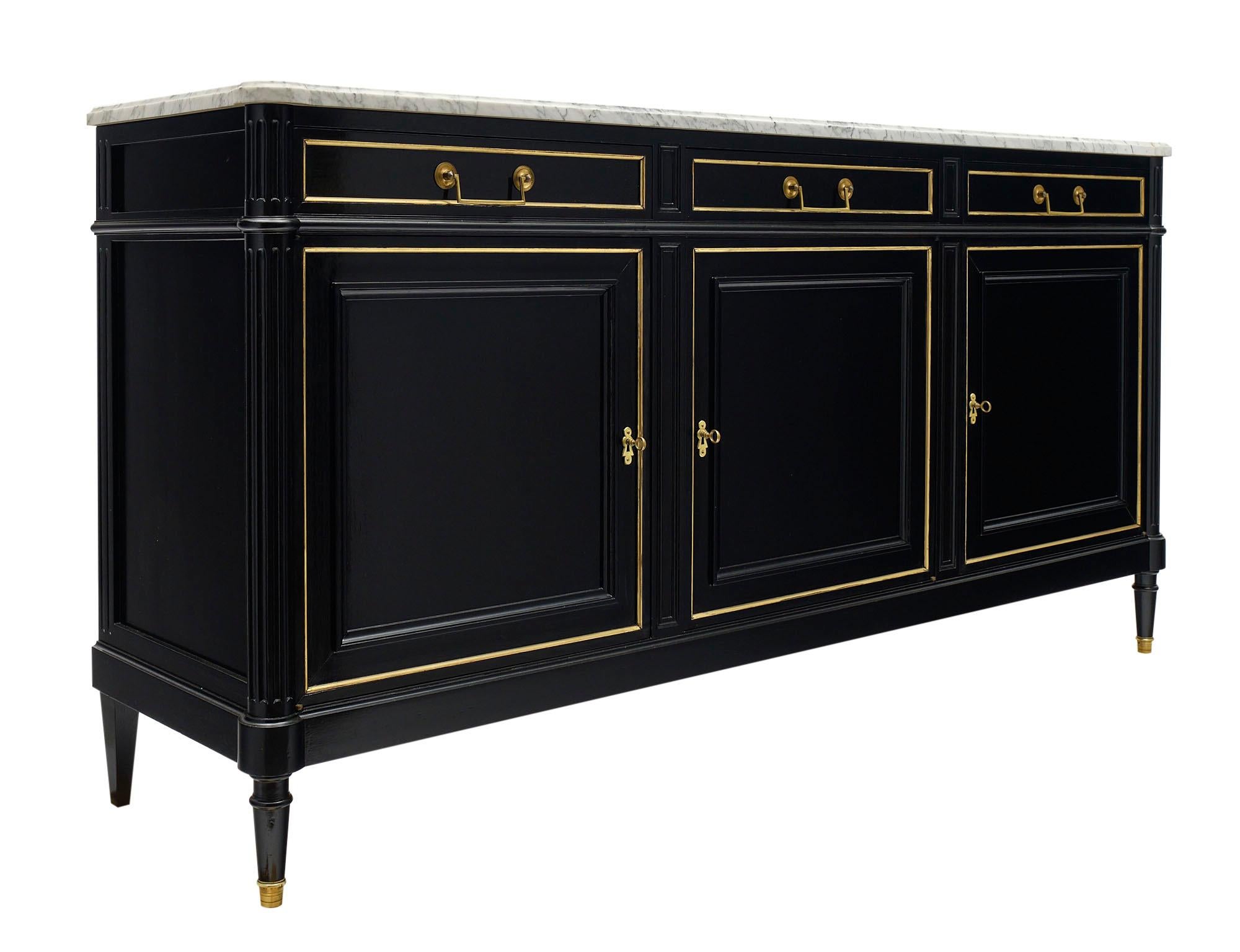 Buffet / enfilade from France made of solid mahogany that has been ebonized and finished in a lustrous museum-quality French polish. Three dovetailed drawers are above three doors opening to adjustable shelving. All locks are in working condition.