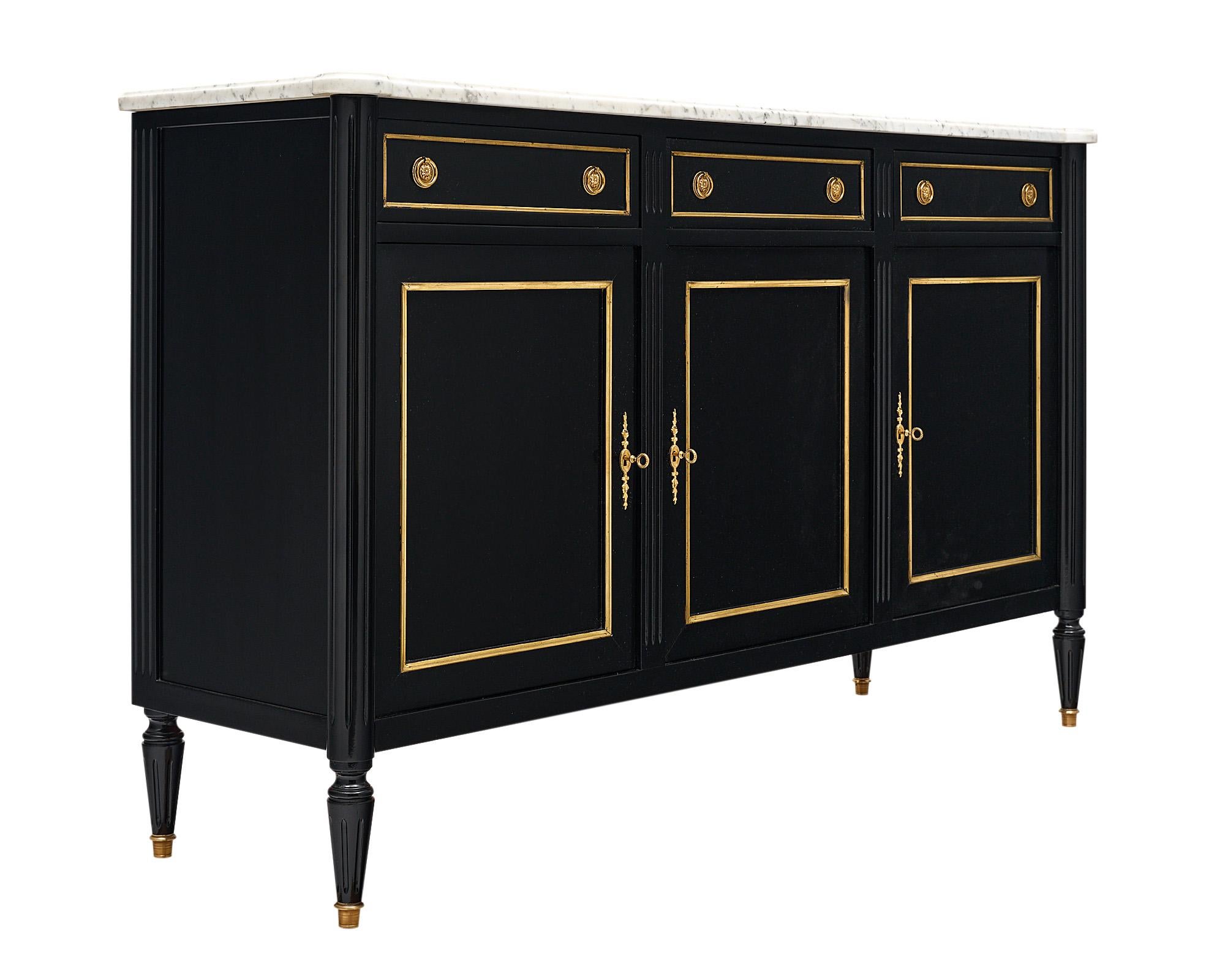 Buffet / enfilade from France made of solid mahogany that has been ebonized and finished in a lustrous museum-quality French polish. Three dovetailed drawers are above three doors opening to interior shelving. All locks are in working condition. The