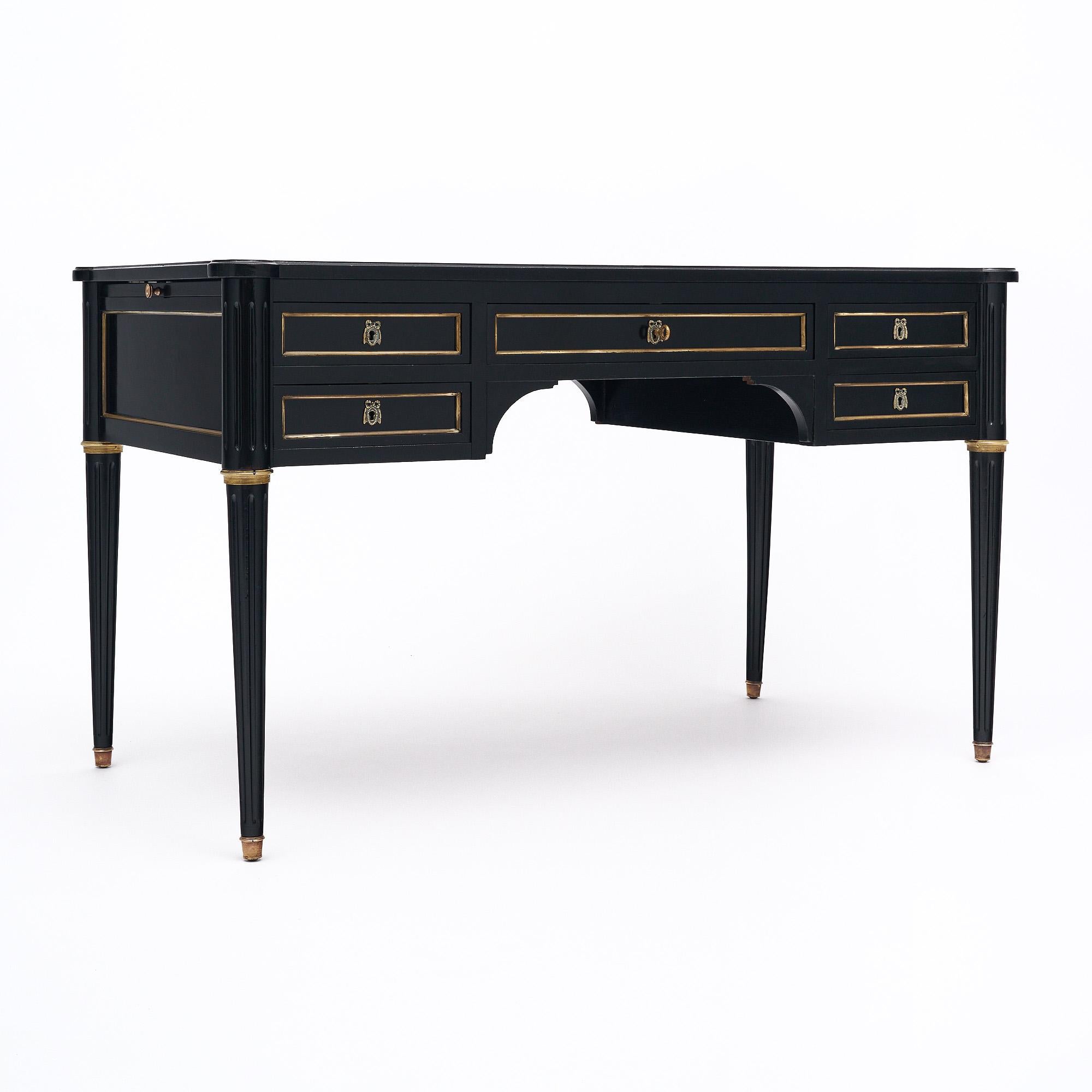Writing desk from France in the Louis XVI style. This piece has been ebonized and finished with a lustrous French polish of museum-quality. There are five dovetailed drawers all with original brass hardware and trim. The key and locks are in working