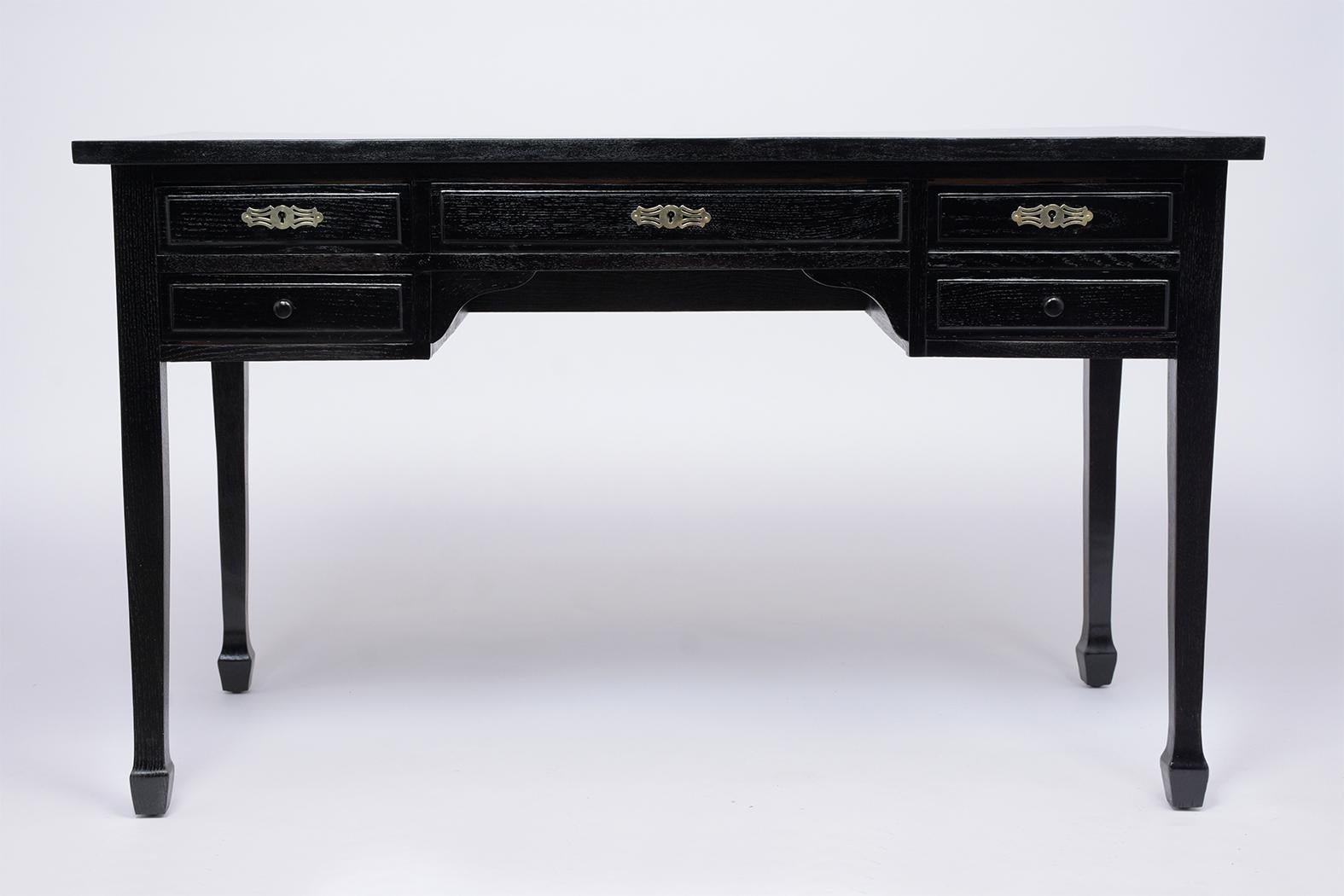 This French Louis XVI style desk circa 1880s is in good condition, made out of oak wood and has a newly ebonized lacquered finish. The desk also comes with two small side drawers on the left side, a large center drawer, and a deep file drawer on the