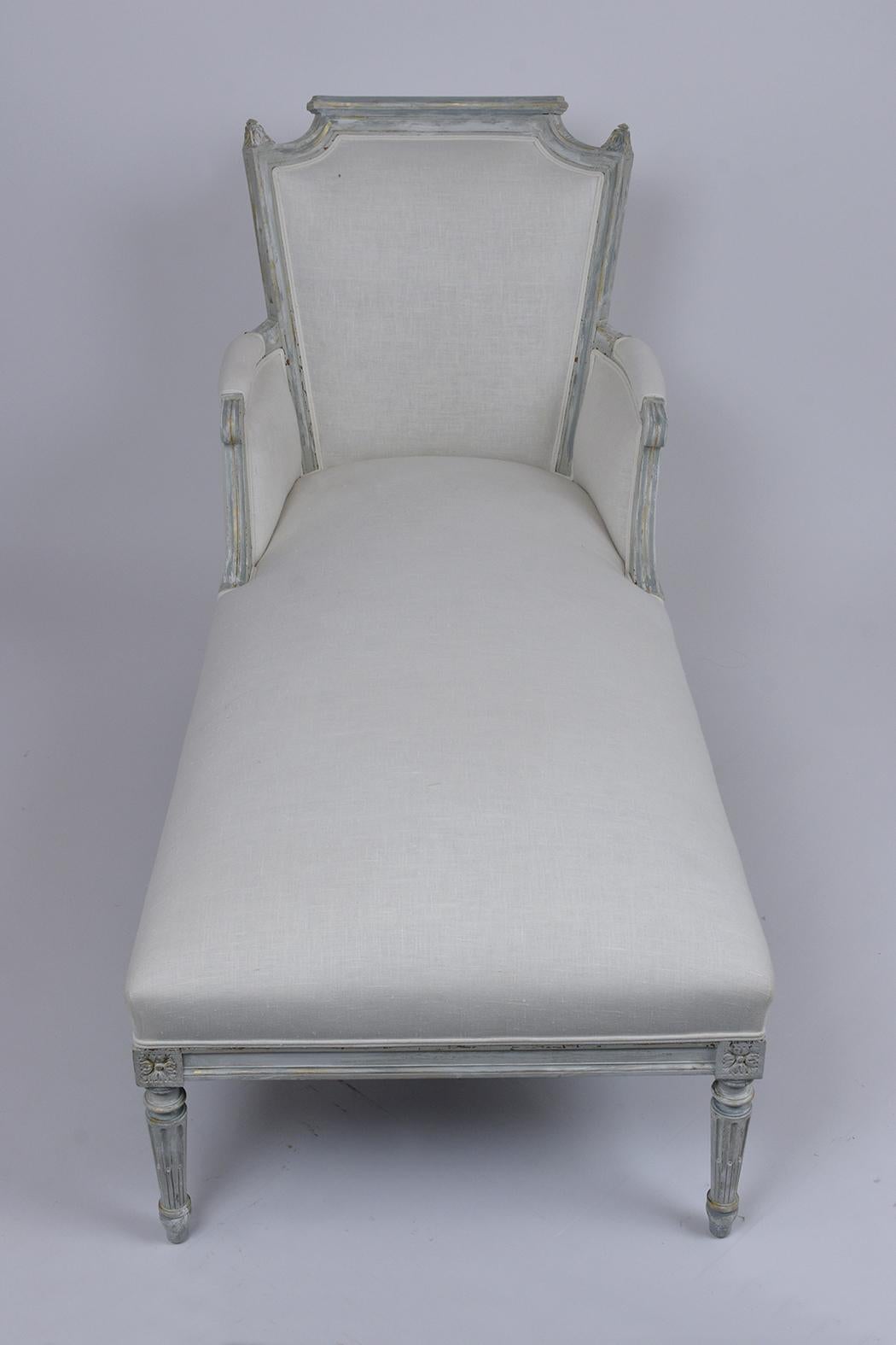 This elegant late 19th century French Louis XVI chaise lounge is made out of solid walnut wood finest craftsmanship and exceptional hand-carved details and is newly painted in pale gray and off-white color combination with a distressed finish by our