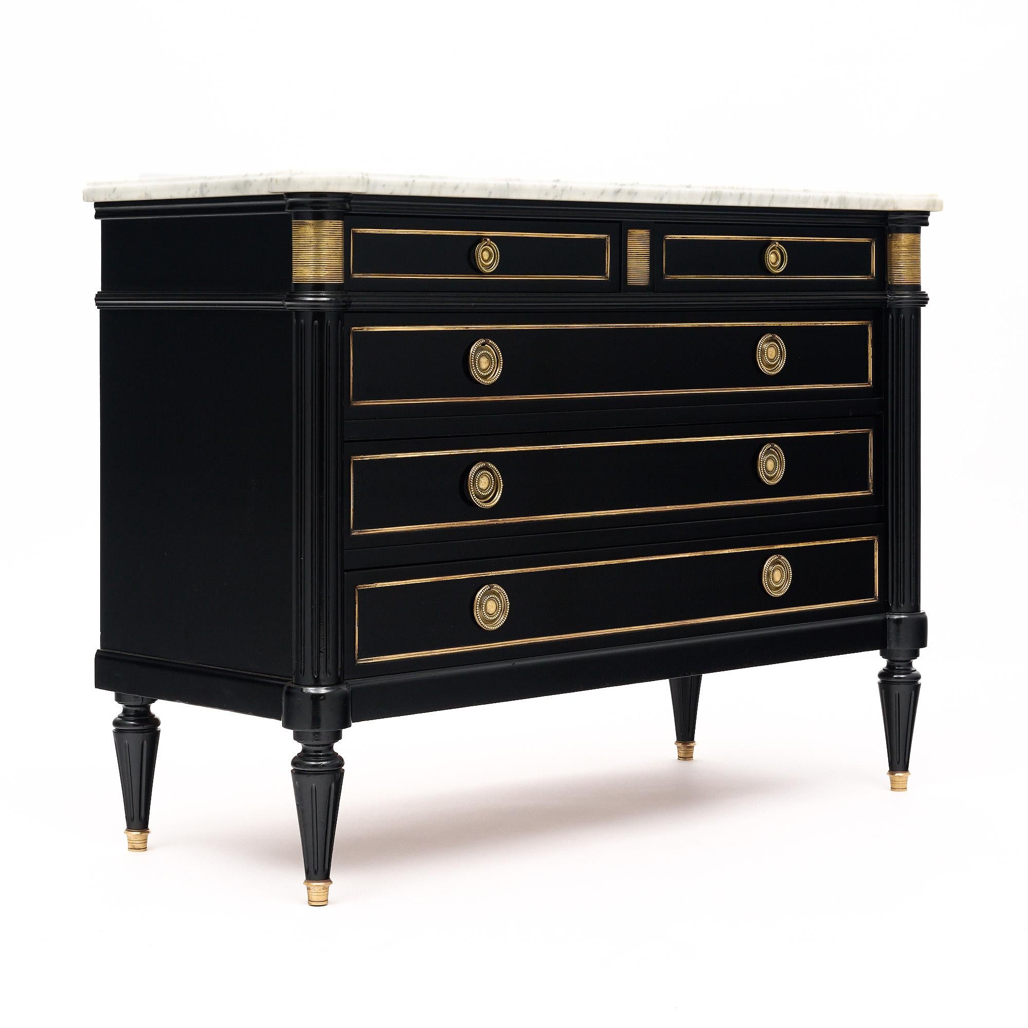 Chest of drawers from France in the Louis XVI Style. This piece is made of mahogany that has been fully ebonized and finished with a lustrous French polish. There are two smaller dovetailed drawers above three large dovetailed drawers for