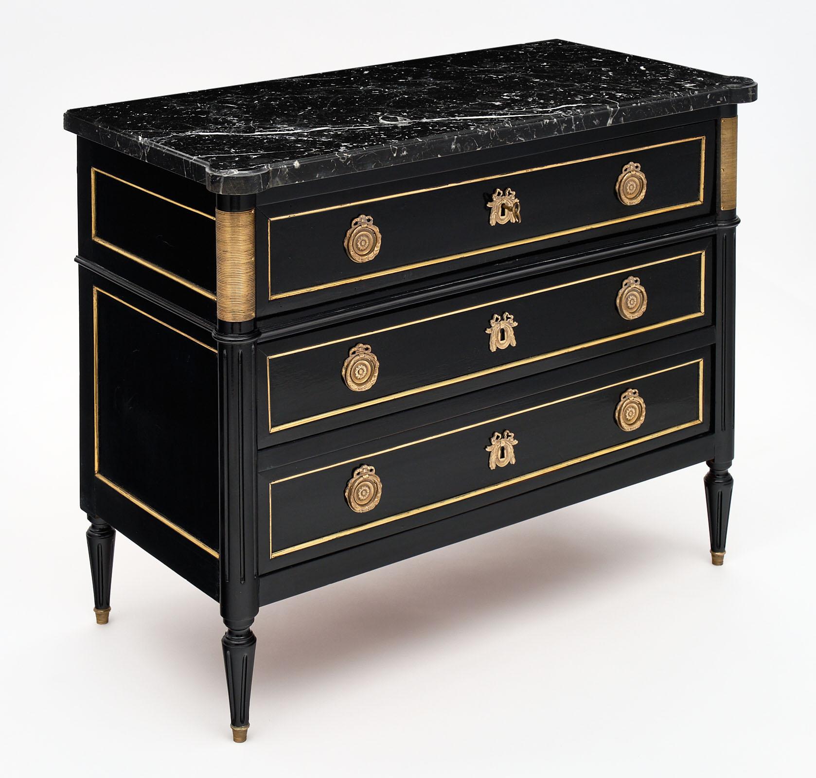 Louis XVI style French antique chest/secretary made of mahogany and finished with an ebony French polish. This commode has two dovetailed drawers and all original finely cast hardware and trim. The top panel folds down and slides out to feature a