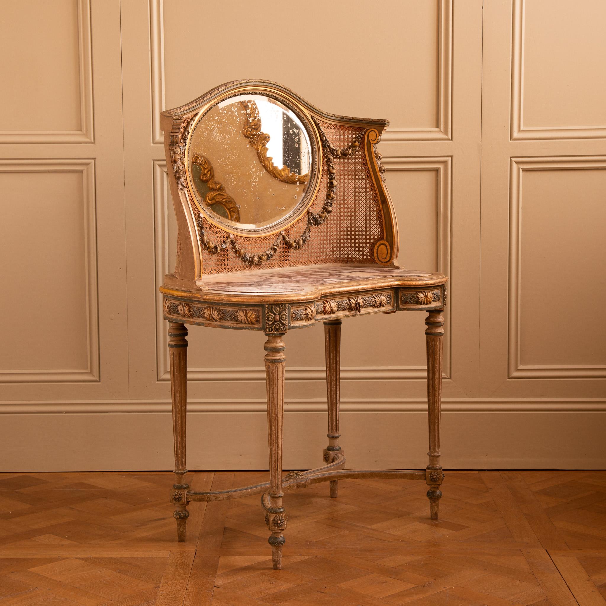 A French, Louis XVI style dressing table/Vanity Unit from the early 1900's with fine carving and a beautiful hand painted finish which accentuates it's detailing. The kidney shape table has a striking Breche Violette marble and a slim line drawer