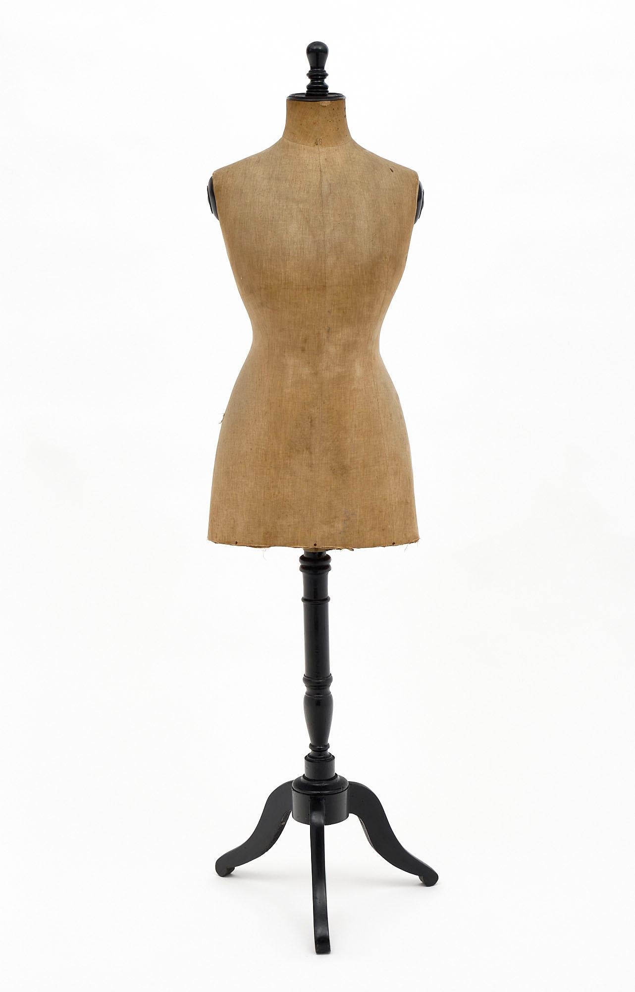 French antique mannequin with handcrafted ebonized pear wood structure and turned stem with a tripod base. It still boasts the original linen body cover.