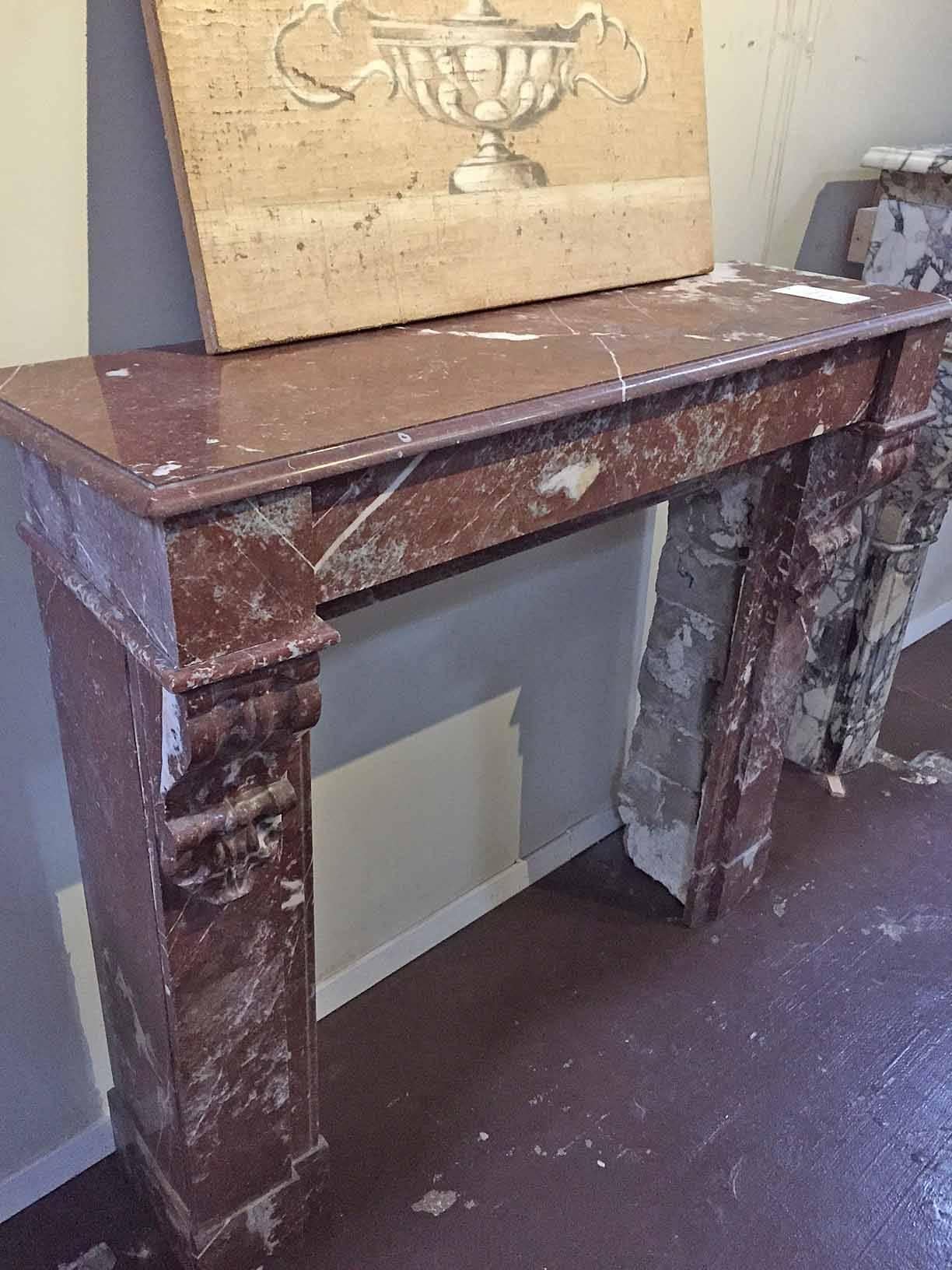 With a straight simple lintel, this antique marble mantel as scroll-like designs on the top of each leg.

Origin: France. 

circa 1880. 

Measurements: 47