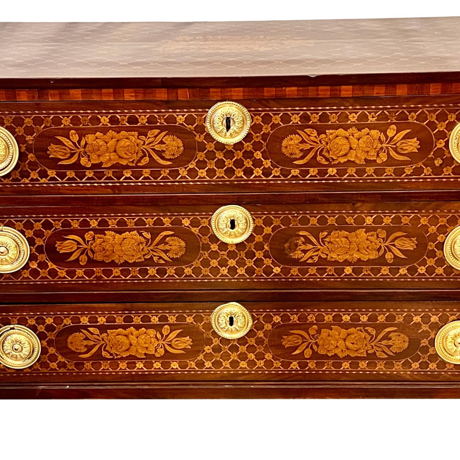 A mid to late 19th century French mahogany marquetry chest of drawers with gilt fittings.

Measurements:
Height: 33