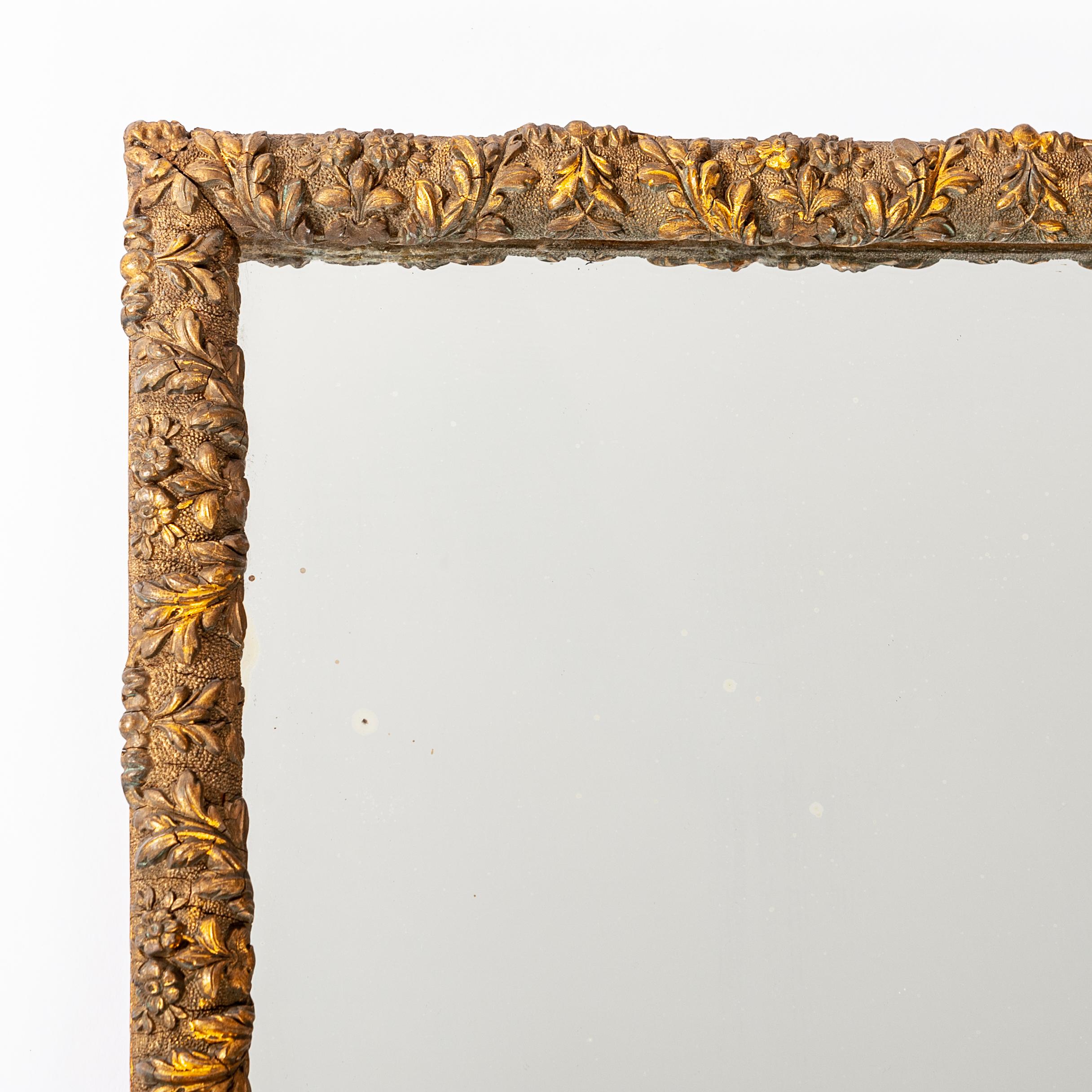 Very finely crafted mirror from the last third of the 19th century in France.
Wooden frame rounded gilded with very finely applied floral stucco, wonderful patina.
Original mercury glass and wooden back part.
  