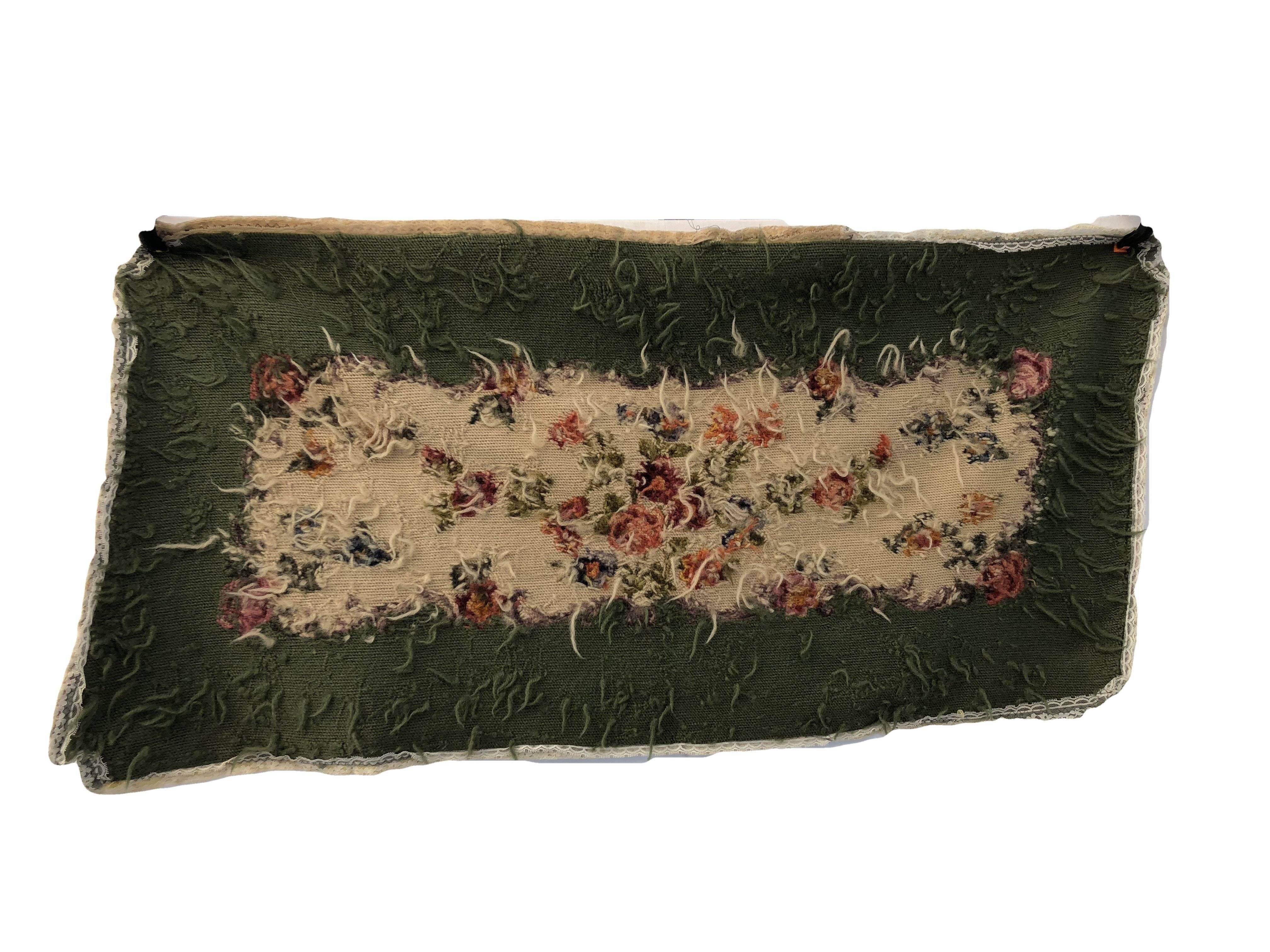 This lovely French silk and wool needlepoint bench cover is in a colorful floral design on a lush green background and finished with lace interior trim. Used as a bench cover or made into a pillow it would add an elegant decorative touch to any room.