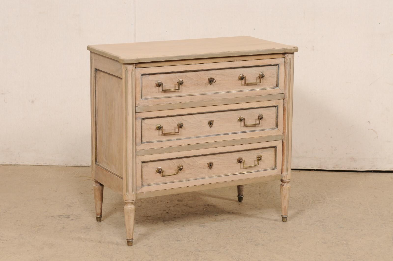 A cute-sized French Neoclassic style chest of drawers from the early 20th century. This antique chest from France features a rectangular-shaped top with pronounced and rounded front corners, which rests atop a neoclassical style case with rounded
