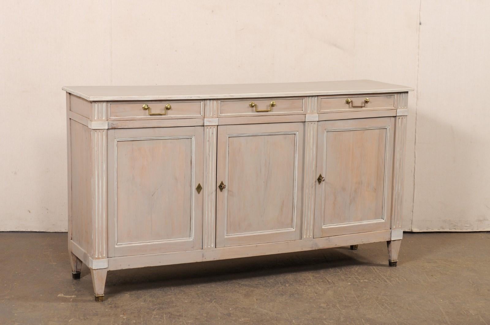 A French painted wood buffet cabinet from the turn of the 19th and 20th century. This antique storage cabinet from France was designed with clean lines, and trim. It features a rectangular-shaped top, approximately 5.75 ft in length, above a case