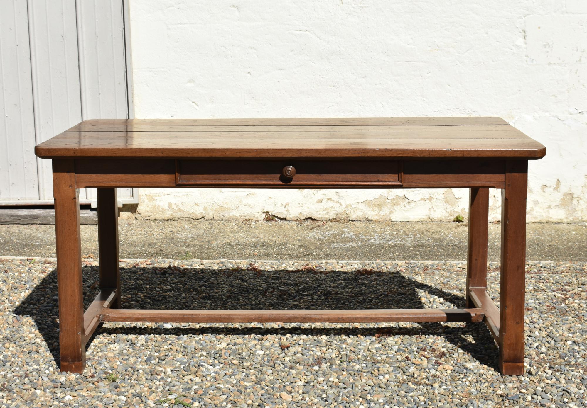 French Antique Oak Extending Farmhouse Table
 
This solid oak dining table features a four plank table top that consists of 4cm bevelled edge planks with later additional slide-in extension leaves for versatile dining options.
 
Constructed in the