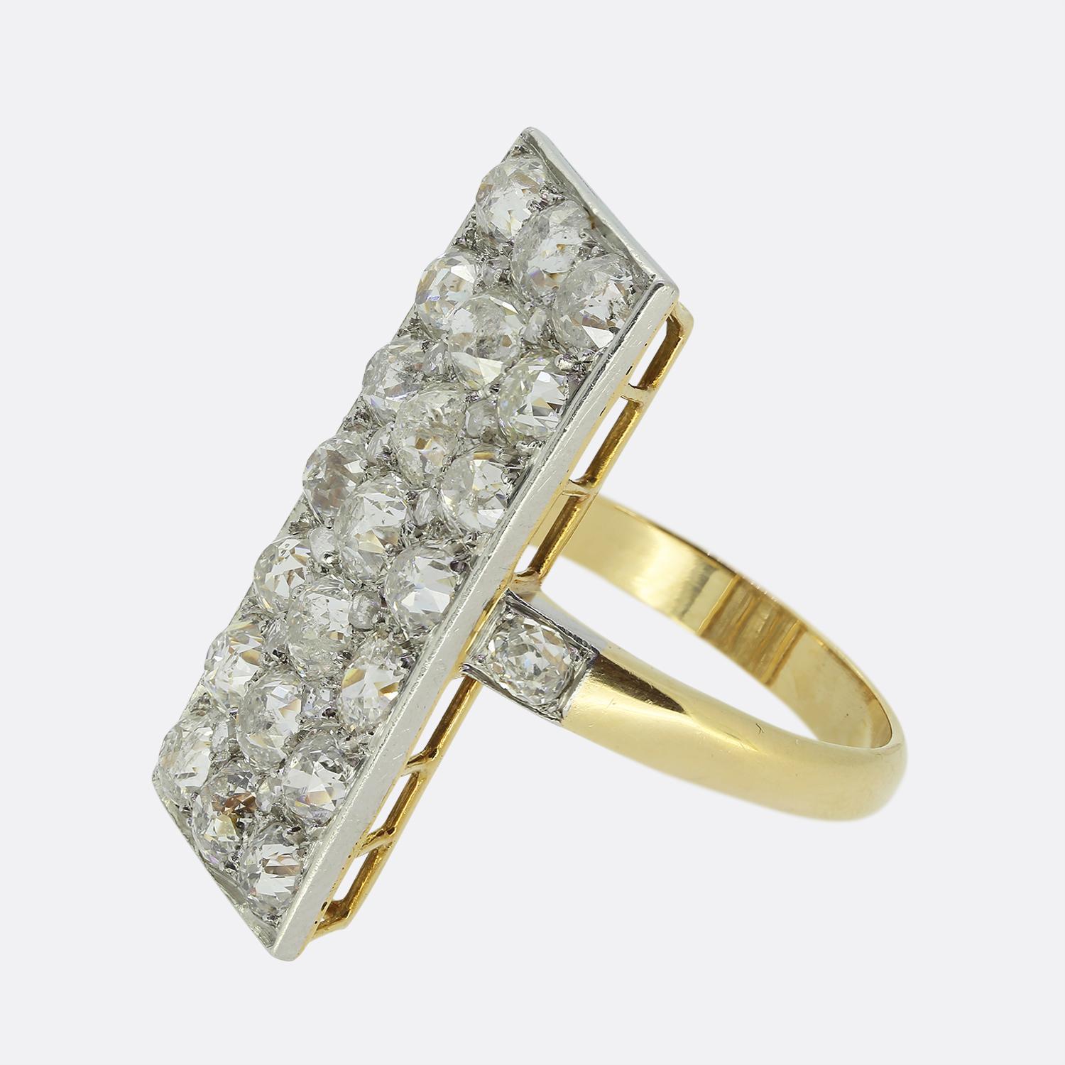 Here we have a fabulous diamond tablet ring dating back to the Edwardian period. The face is a rectangular shape and has been set with numerous round faceted chunky old mine cut diamonds. The shoulders are adorned with an additional matching stone