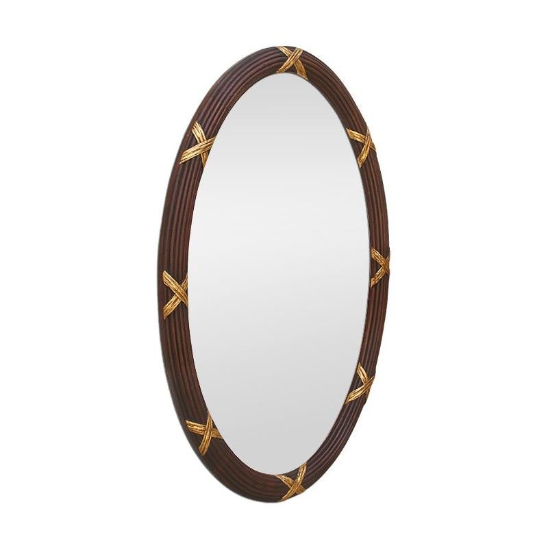Large French antique oval mirror. Carved wood frame with fluting and gilded crosspieces. Stained wood, re-gilding to the patinated leaf. Antique frame width: 5 cm / 1.96 in. Modern glass mirror. Antique laminated wood back.