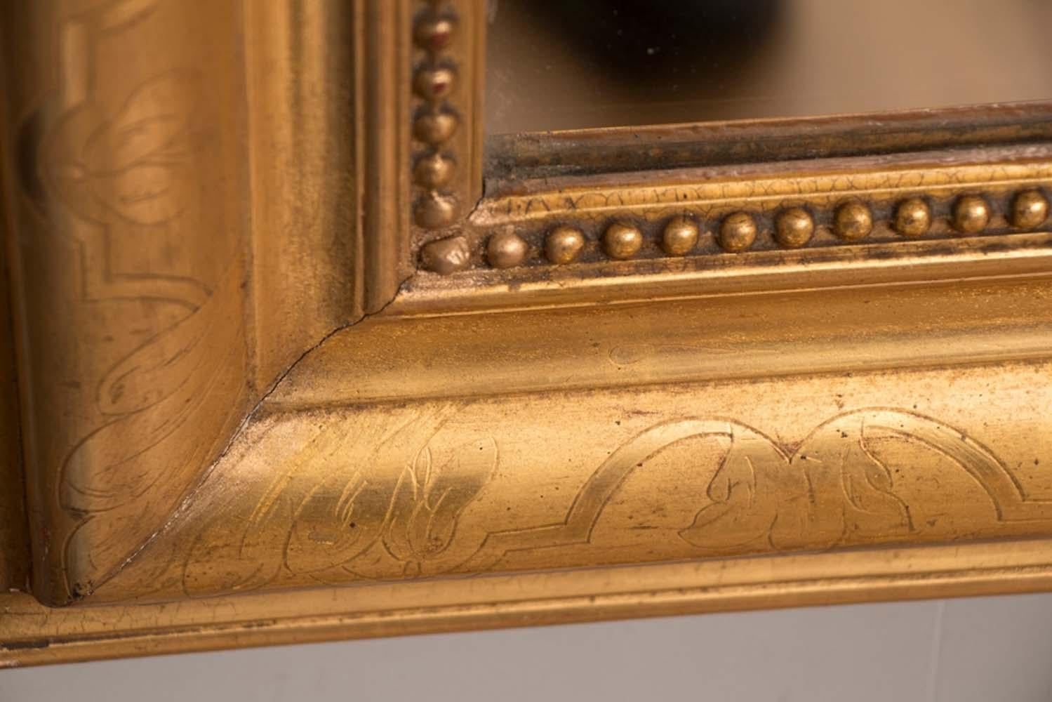 This is an absolutely superb original gilded French mirror bought from a home in Paris and is untouched and has a near immaculate original gilded condition.

There are a few surface scratches on the original mirror plate, however nothing which