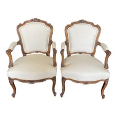 French Antique Pair of Intricately Carved Louis XV Walnut Arm Chairs Bergeres