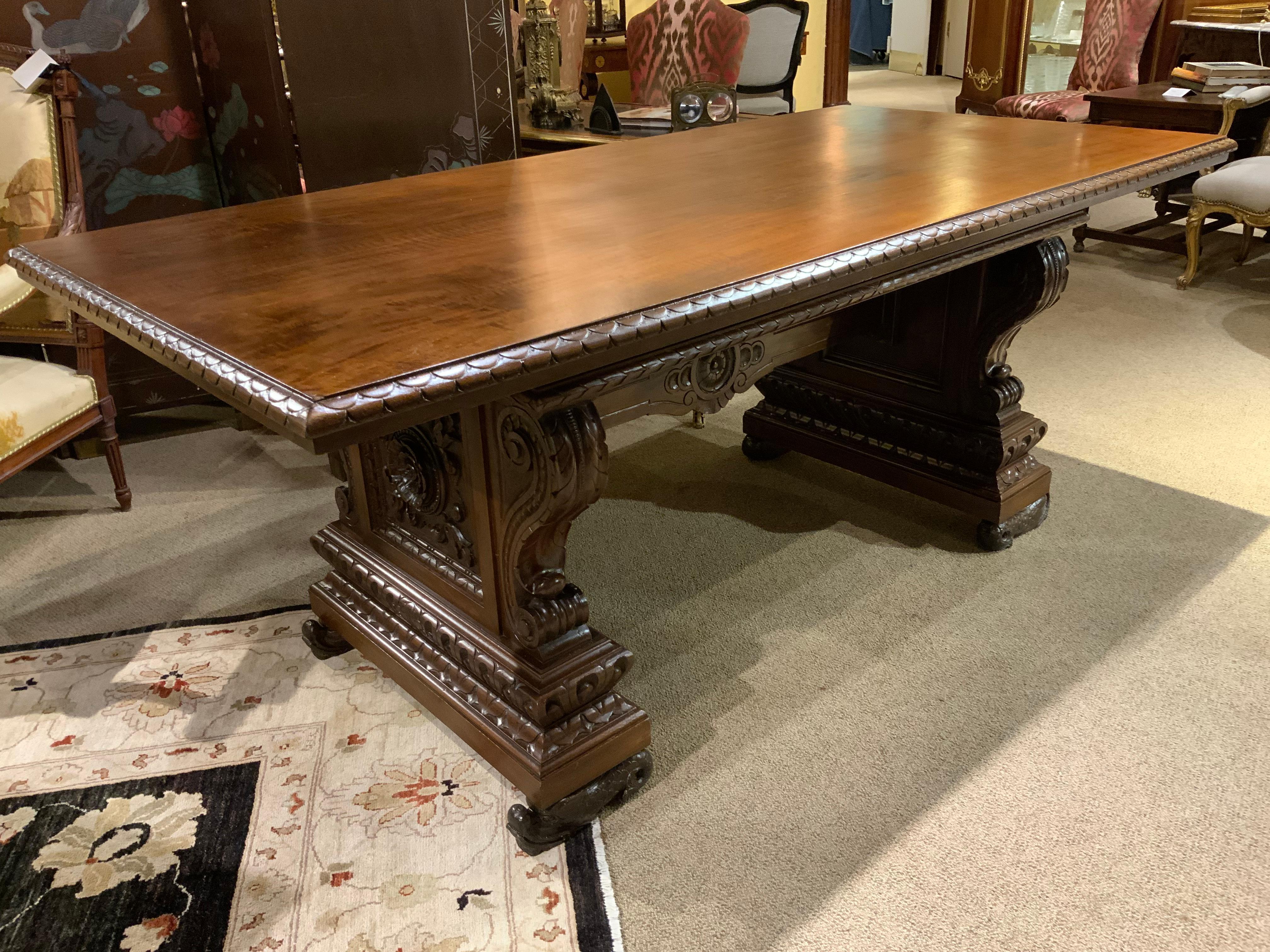 This carved table is made of walnut and was carved by hand
In France in the Renaissance style. Both ends are curved and carved
In a S shape with a square carving at the center. The two ends support
This piece and are connected with a carved