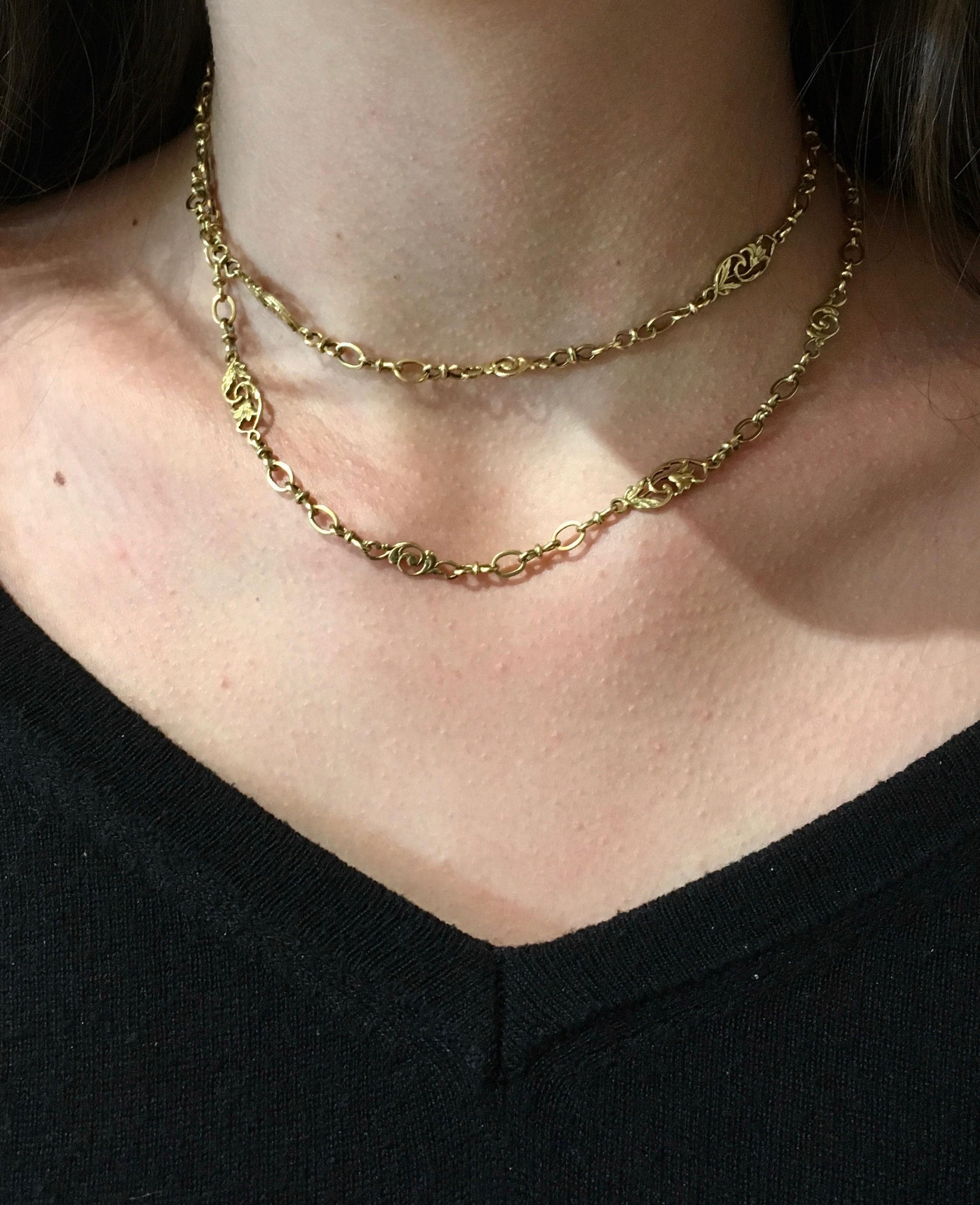 Beautiful Lillies link together with leaves and vines in this 18K Yellow Gold chain link necklace. Antique and French this Sautoir Necklace is 30 inches long and can be worn in a multitude of ways- from lariat to twice around. Made in France in 1890