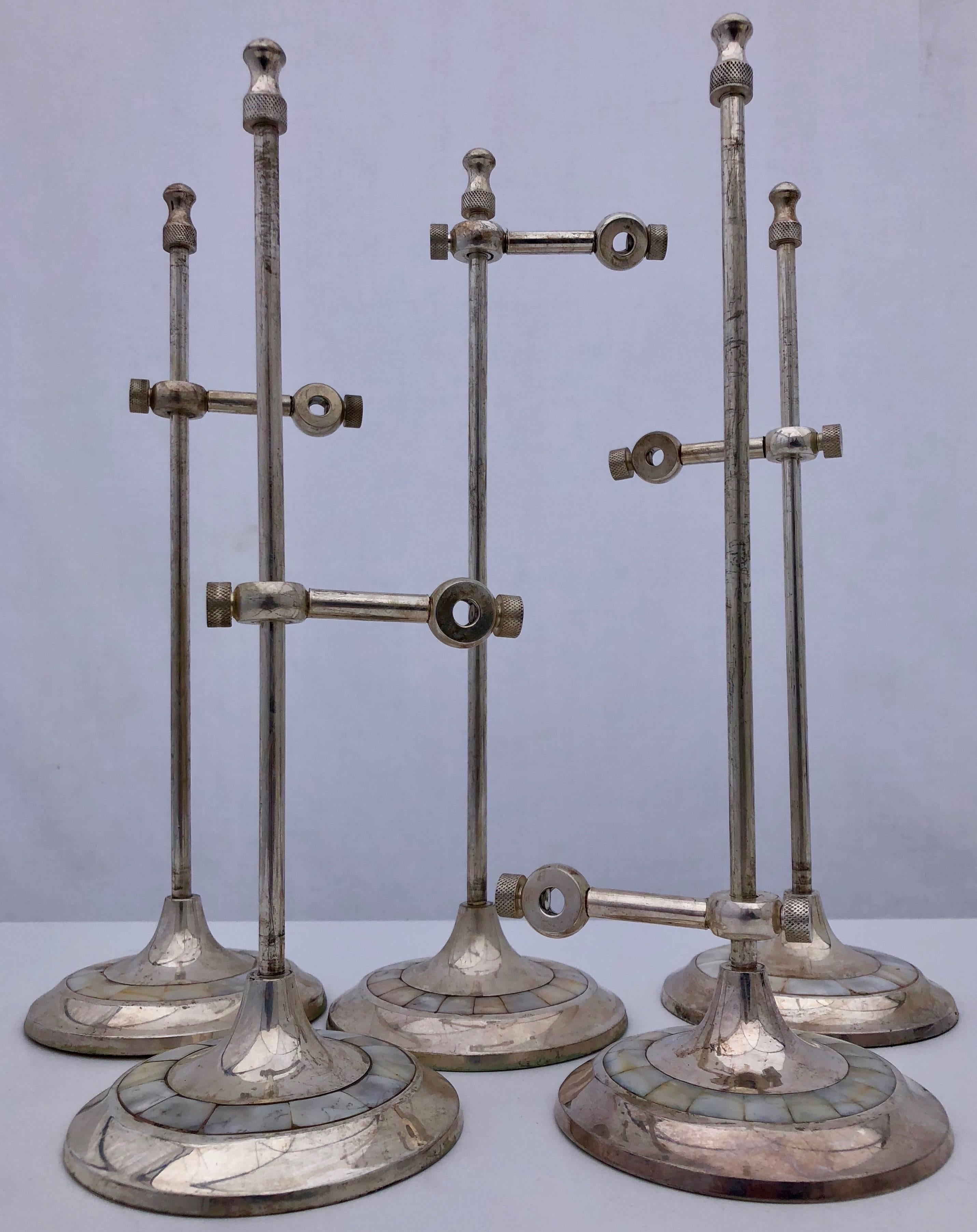 This set of five French antique silver plated tabletop sign holders have a mother of pearl inlay design on the base and are loaded with weight to keep them upright even when holding a heavier sign. They were previously used in a French hotel bar,