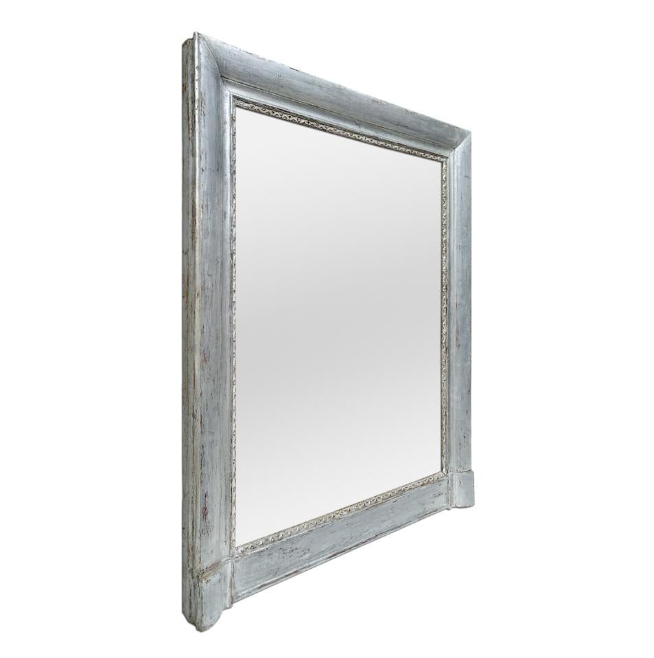 Antique mantel mirror, Louis-Philippe French style, circa 1890. Antique silvered wood mirror frame with stylised decor at the edge the glass. Re-gilding to the leaf patinated. Antique frame width 9.5 cm / 3.74 in. Modern glass mirror. Antique wood