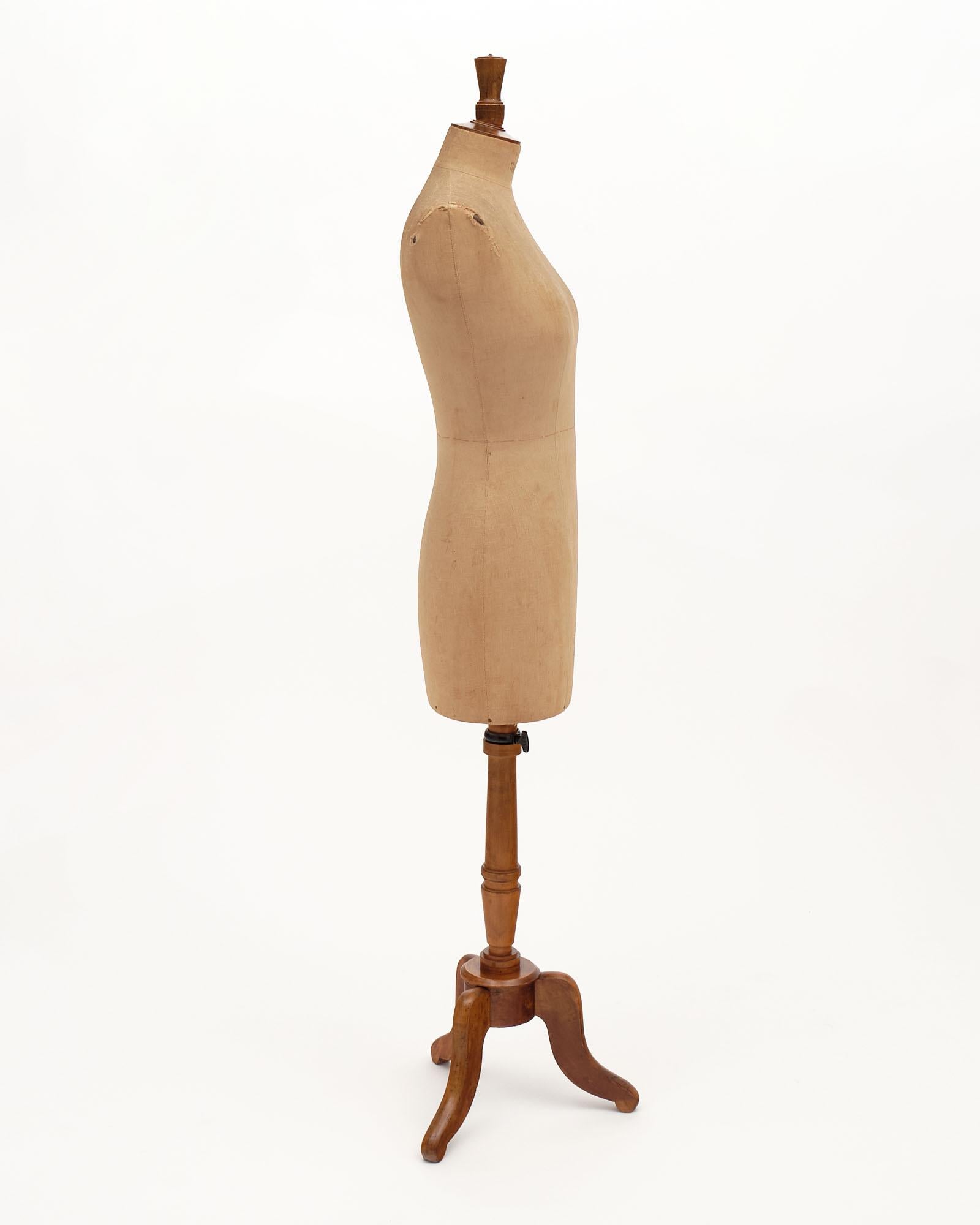 French Antique Couture Dress Mannequin from the iconic 19th century Parisian firm Stockman. This mannequin is made of canvas on wood with a solid walnut tripod adjustable base.