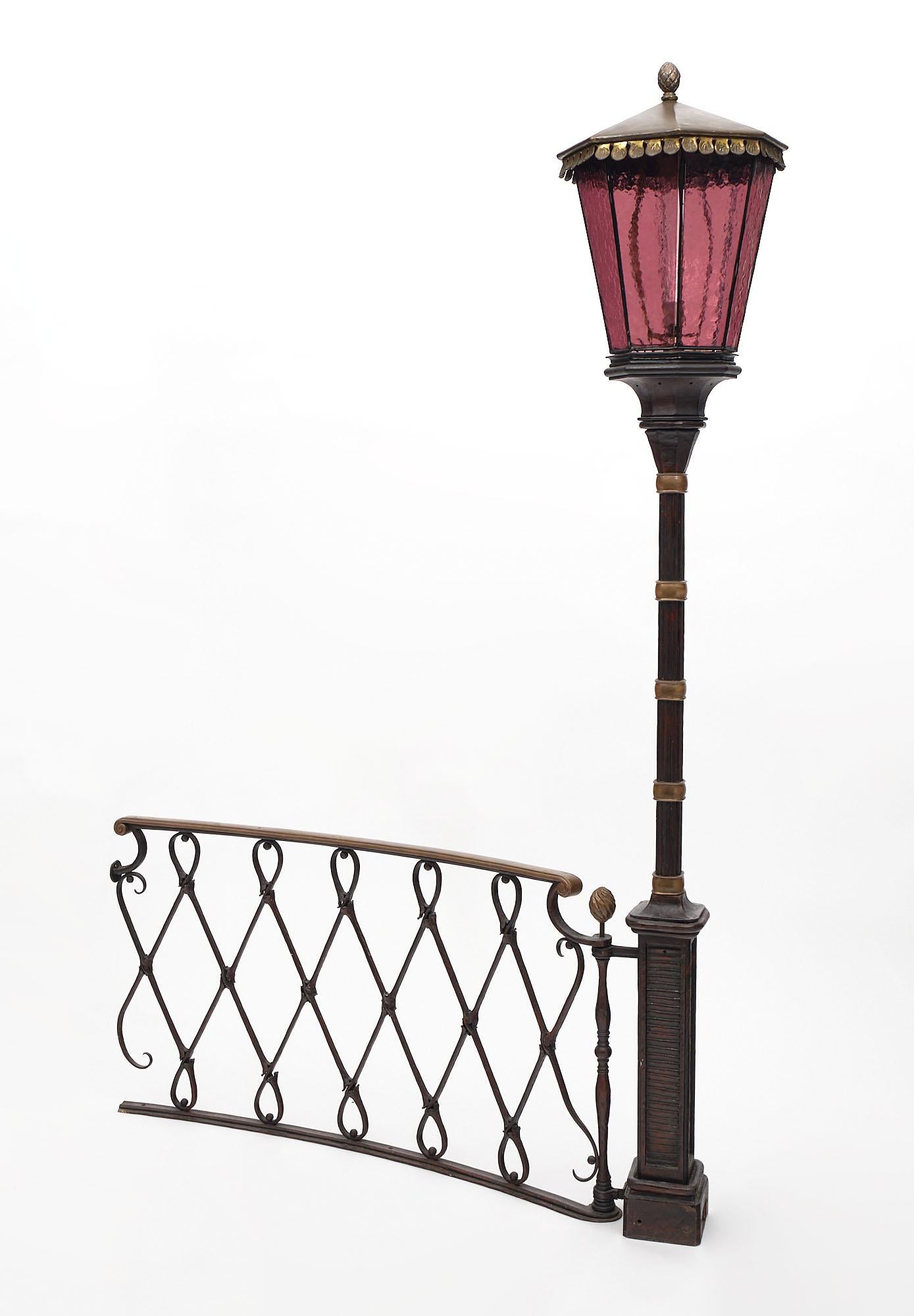 Important street lamp from France made of hand hammered wrought iron with patinated bronze details. This piece also features a wrought iron railing. It has a beautiful patina and very high quality craftsmanship in the manner of Diego Giacometti.