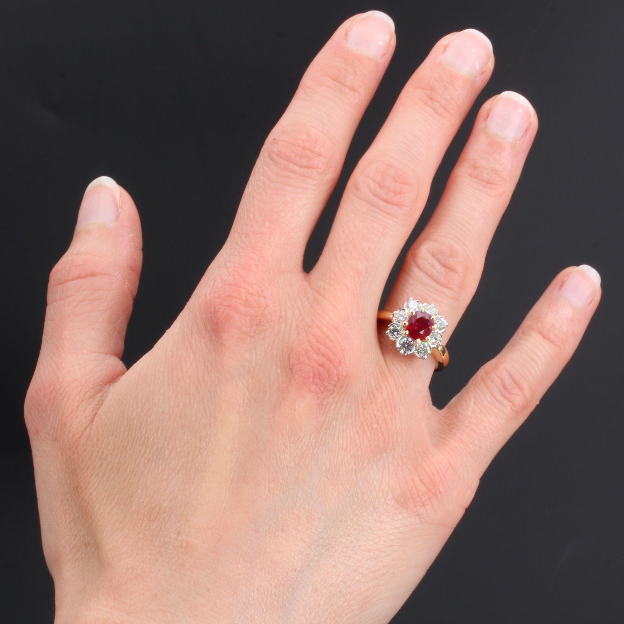 Ring in 18 karat yellow gold, eagle head hallmark and platinum, dog head hallmark.
Lovely flower ring, it is set in the center with yellow gold claws, of a ruby in a surround of modern brilliant- cut diamonds set on platinum. The ring is