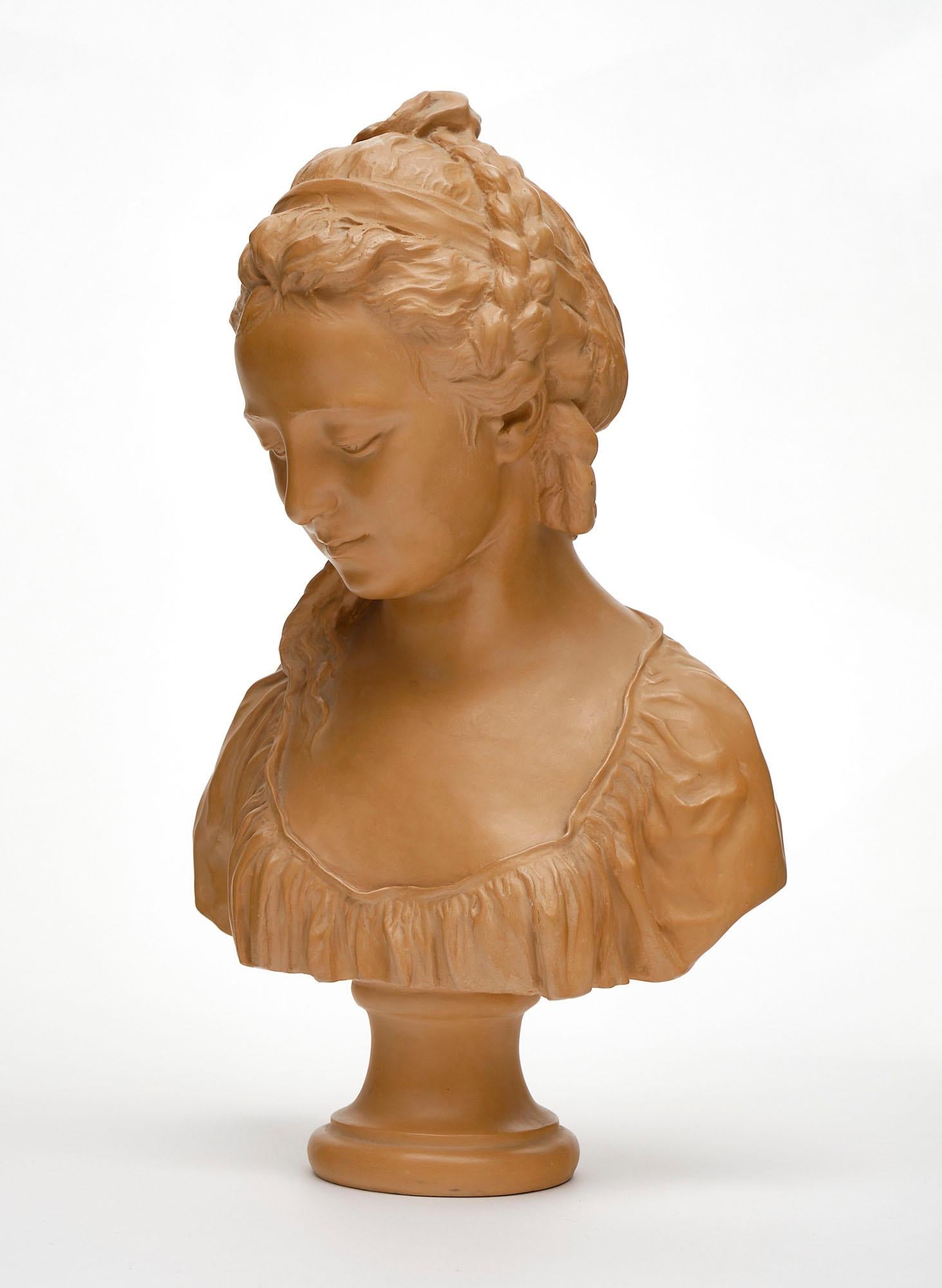 Sculptural bust from France hand-crafted in terracotta. This finely detailed vintage work of art features the likeness of a woman and has a wonderful warm tone.