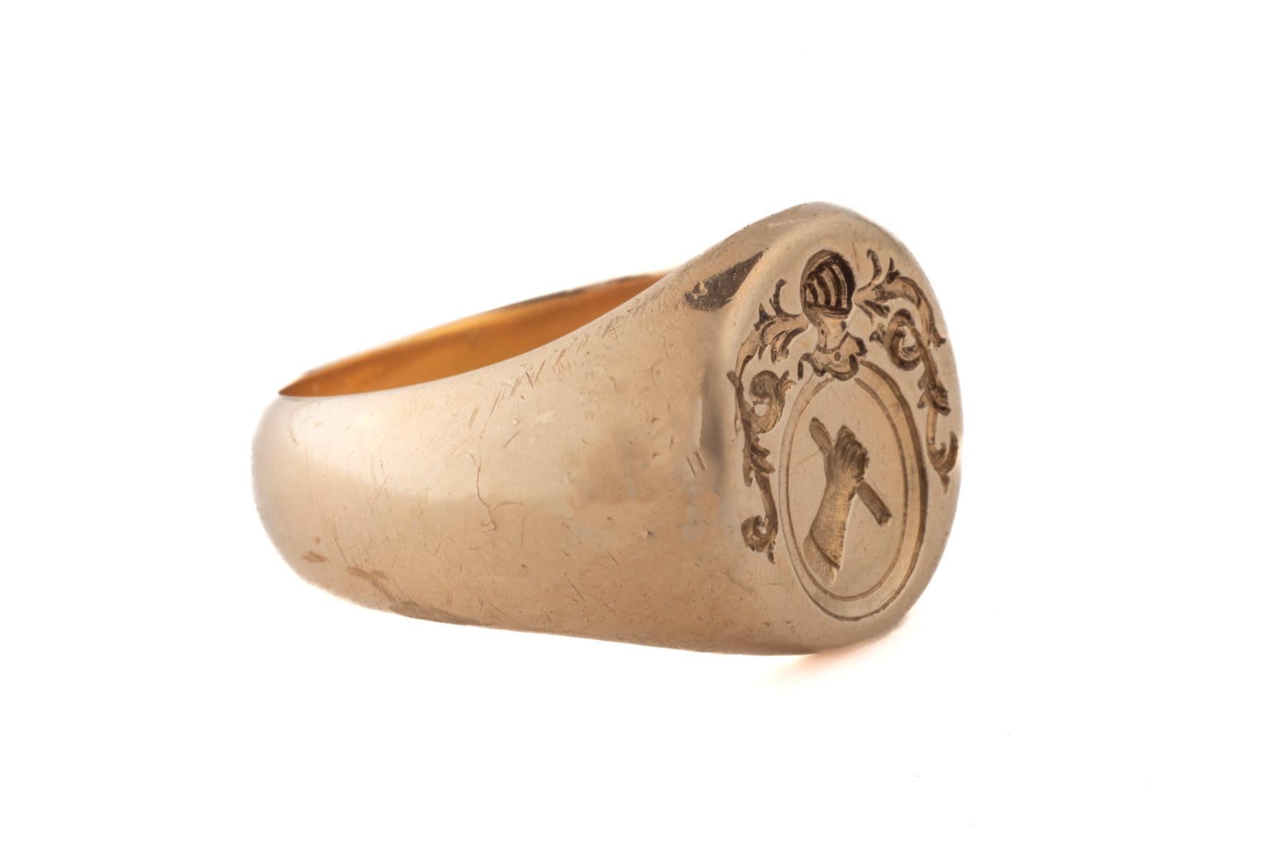 A French Victorian 15 Kt signet ring that shows all the signs of power. There is an arm raised up showing a dagger. This symbol shows the willingness to prevail. Above the arm is a warriors helmut with face protector. 
this was either the ring of a