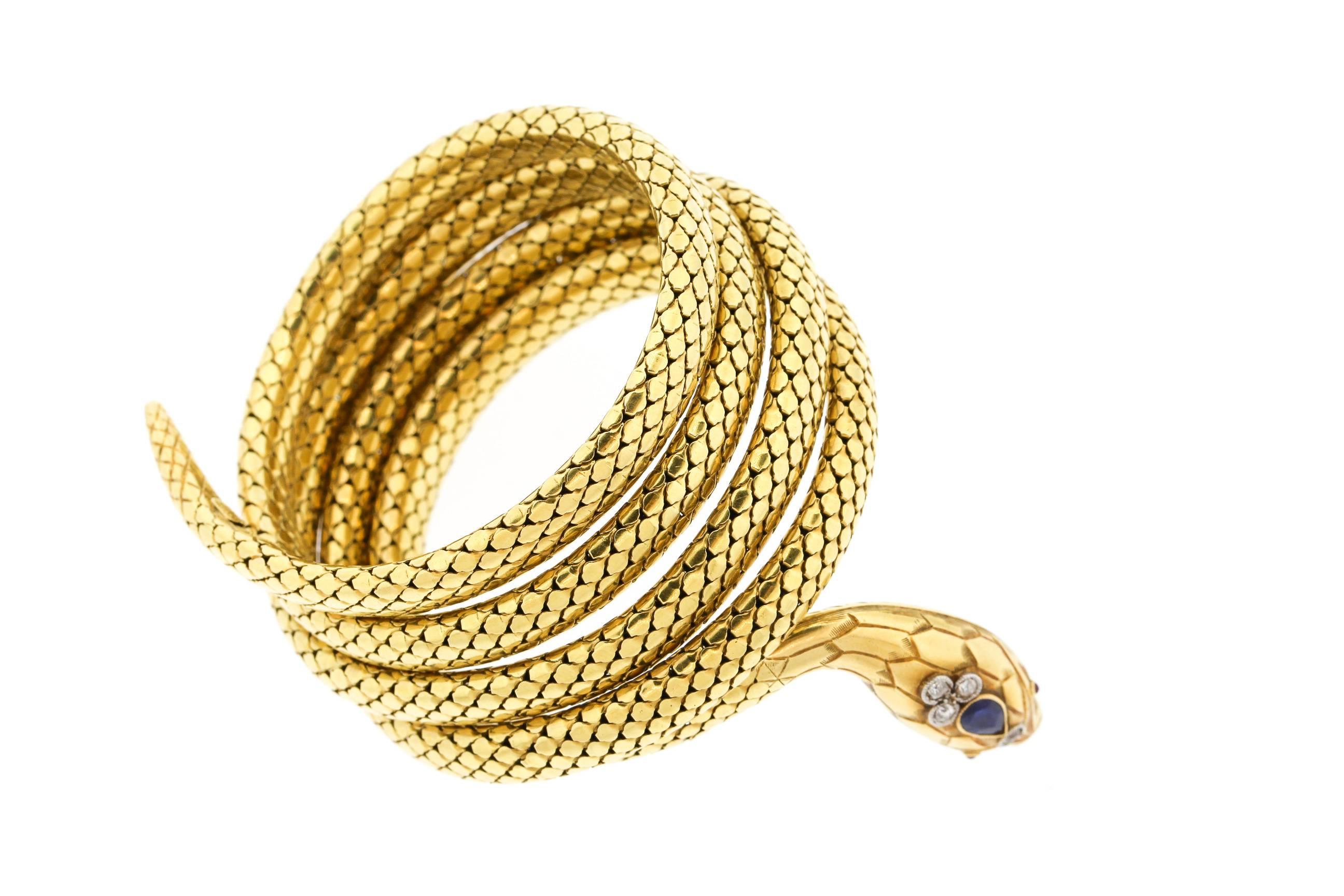 A late Victorian coiling 18k gold snake bracelet, made in France.  The bracelet wraps around the wrist 5 times, and is in a nice tight condition.  It has spring and the gold is silky smooth.  The snake's head is set with a blue sapphire weighing