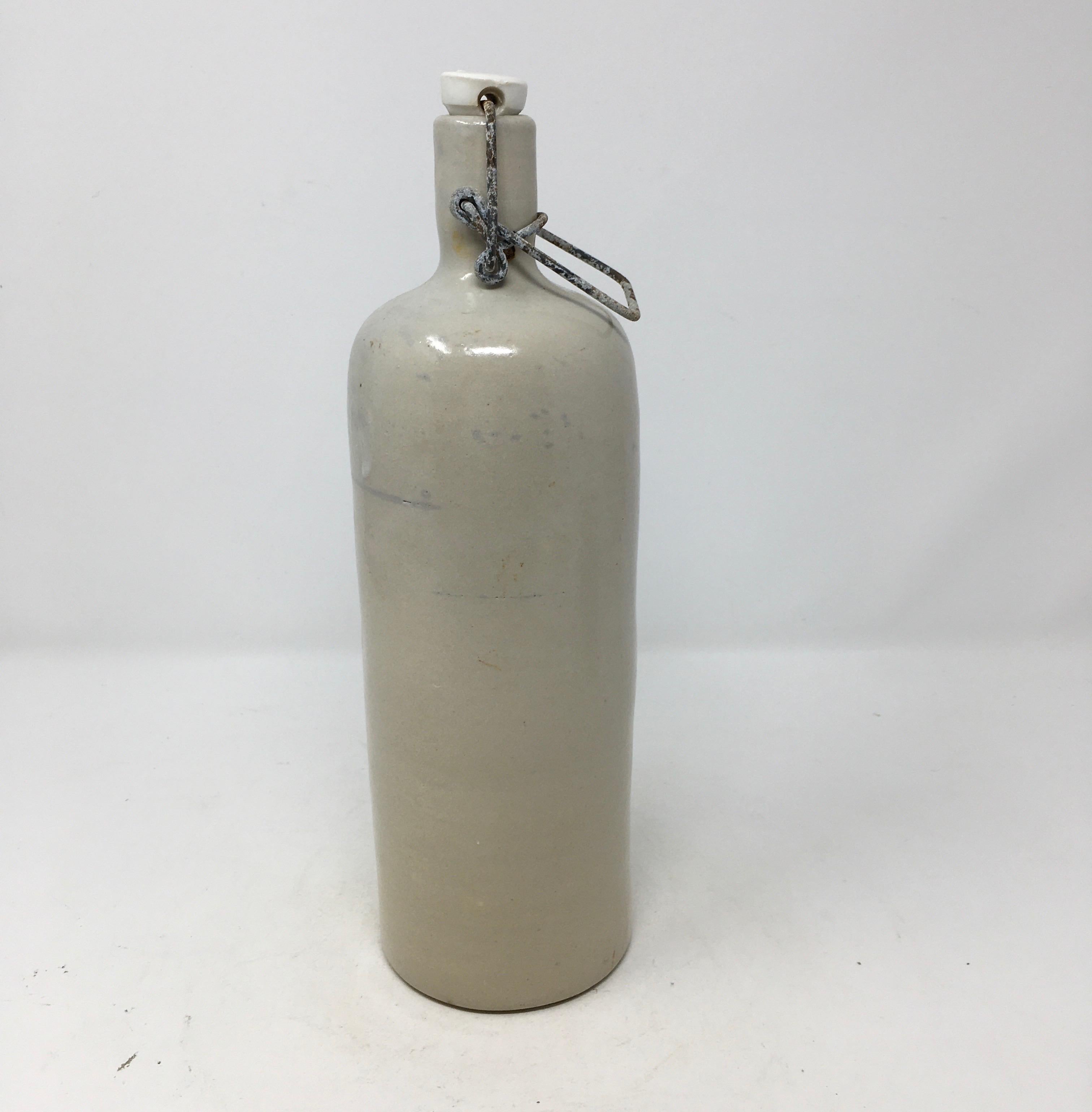 Found in the South of France this antique stoneware vinegar bottle has its original porcelain top attached. Simplistic in design the piece could be used as a kitchen accessory or as a vase for a single flower. 

This piece weighs 2 lbs.