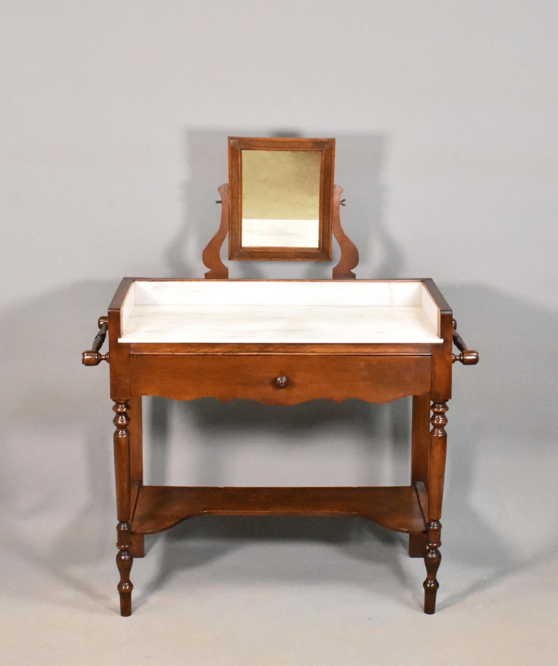 French antique washstand Louis Philippe Style 

This well-proportioned beech washstand features a variegated white and grey marble top and surround enclosed within the wooden frame. 

To each side are matching turned towel rails and there is a
