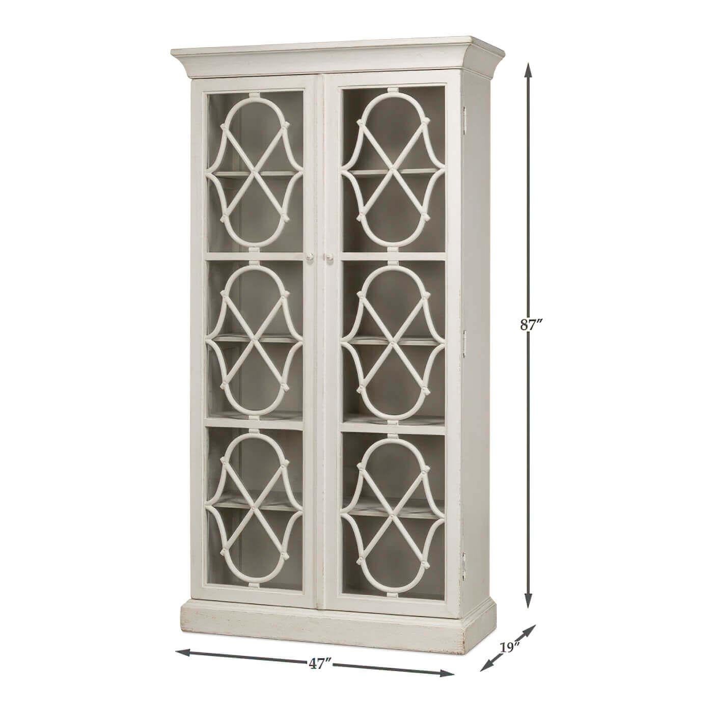 This tall, gracefully structured cabinet is finished in a serene antique white, exuding timeless sophistication. The striking windowpane doors, adorned with a geometric lattice design, not only add a decorative touch but also allow glimpses of your
