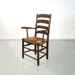 French antique wood oak and straw chair with armrests decorations, late 1800s