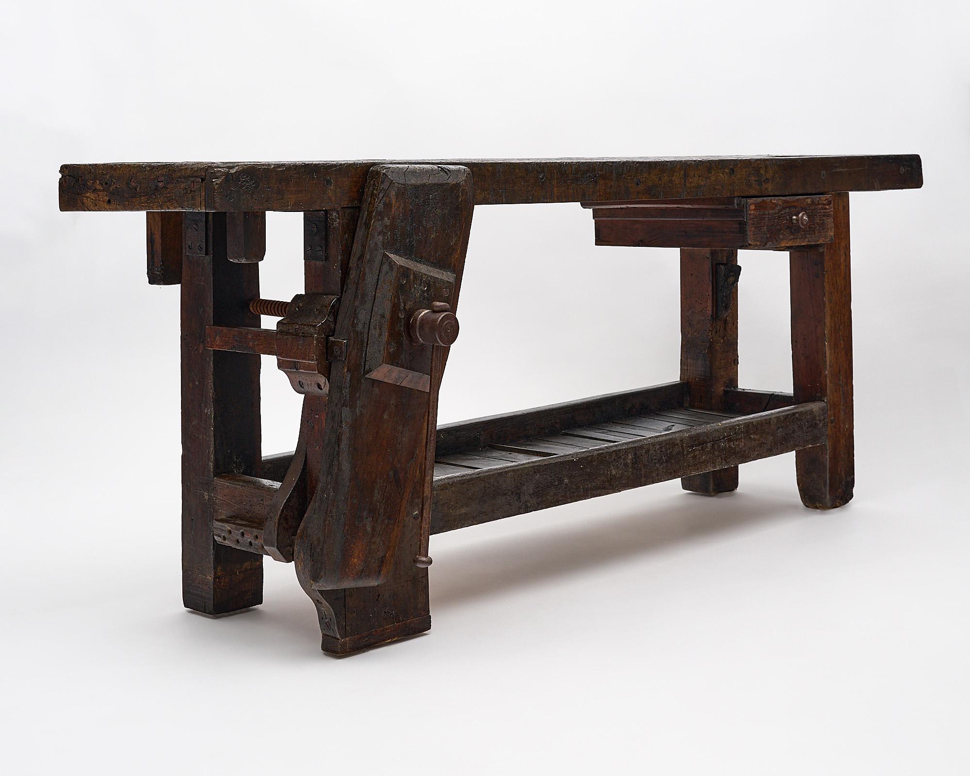 Carpenter’s work bench, French, made of waxed beech wood from the French Alps. This industrial “etabli” features its original vise and drawer. The depth listed includes the vise, the depth of the table top is 17”.